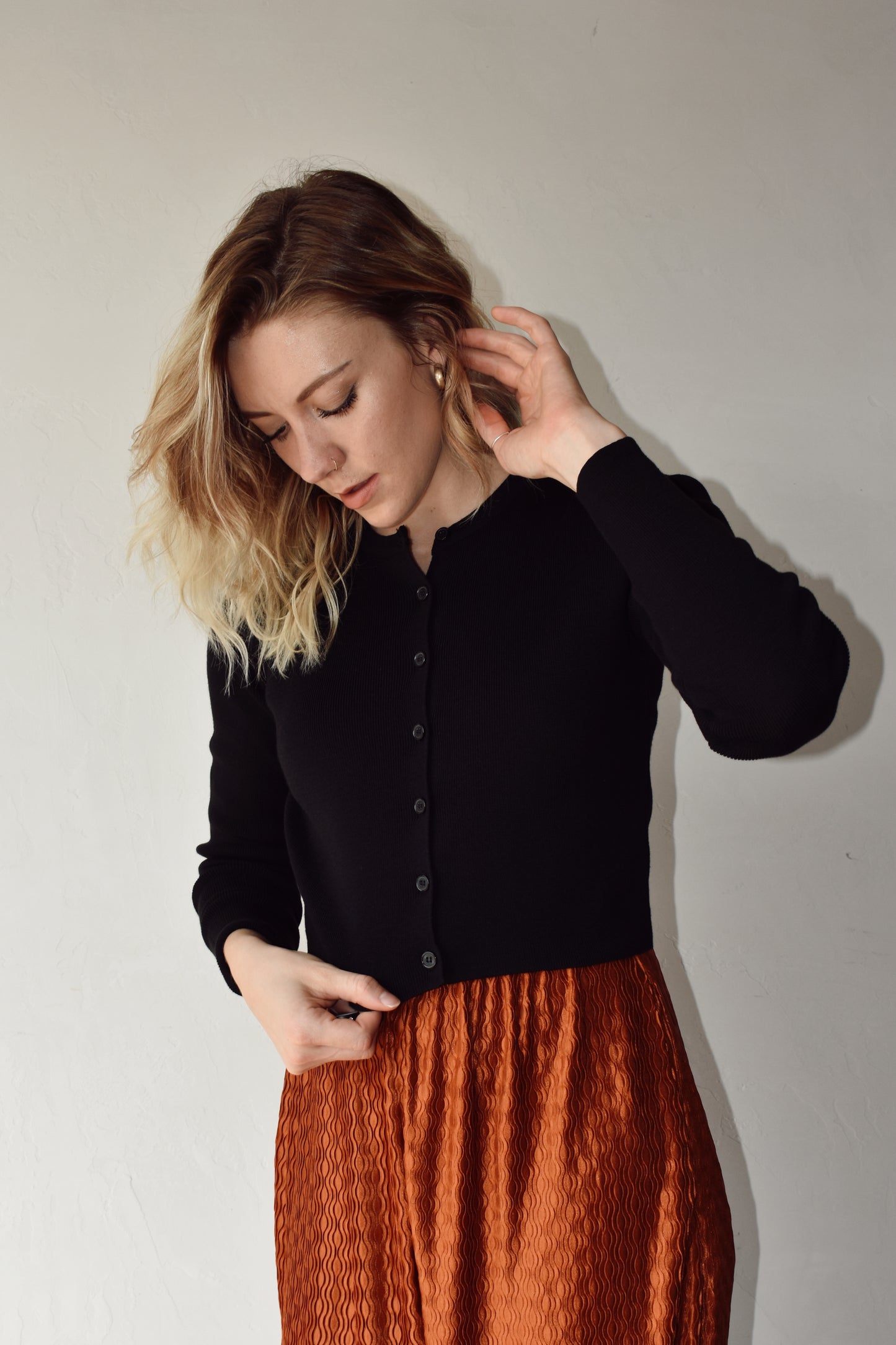 fitted ribbed knit full button cardigan. waist length crew neck when buttoned. black color