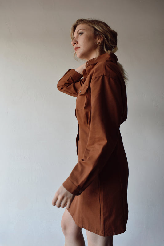 twill rust brown long sleeve utility dress flap breast pockets, collar, button down front and drop shoulders, slightly loose fitting