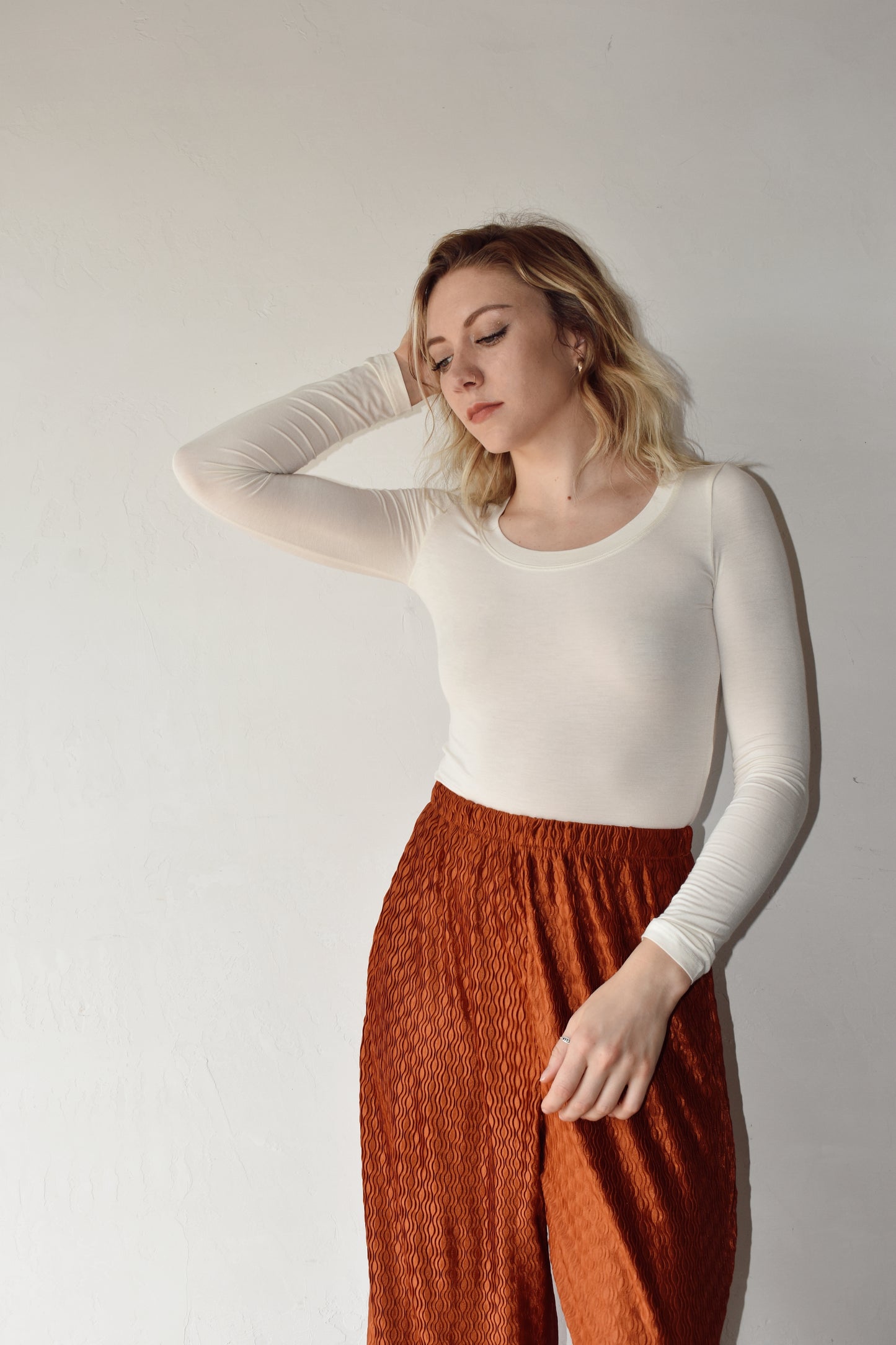 ivory long sleeve fitted crop top with scoop neck and stretchy fabric