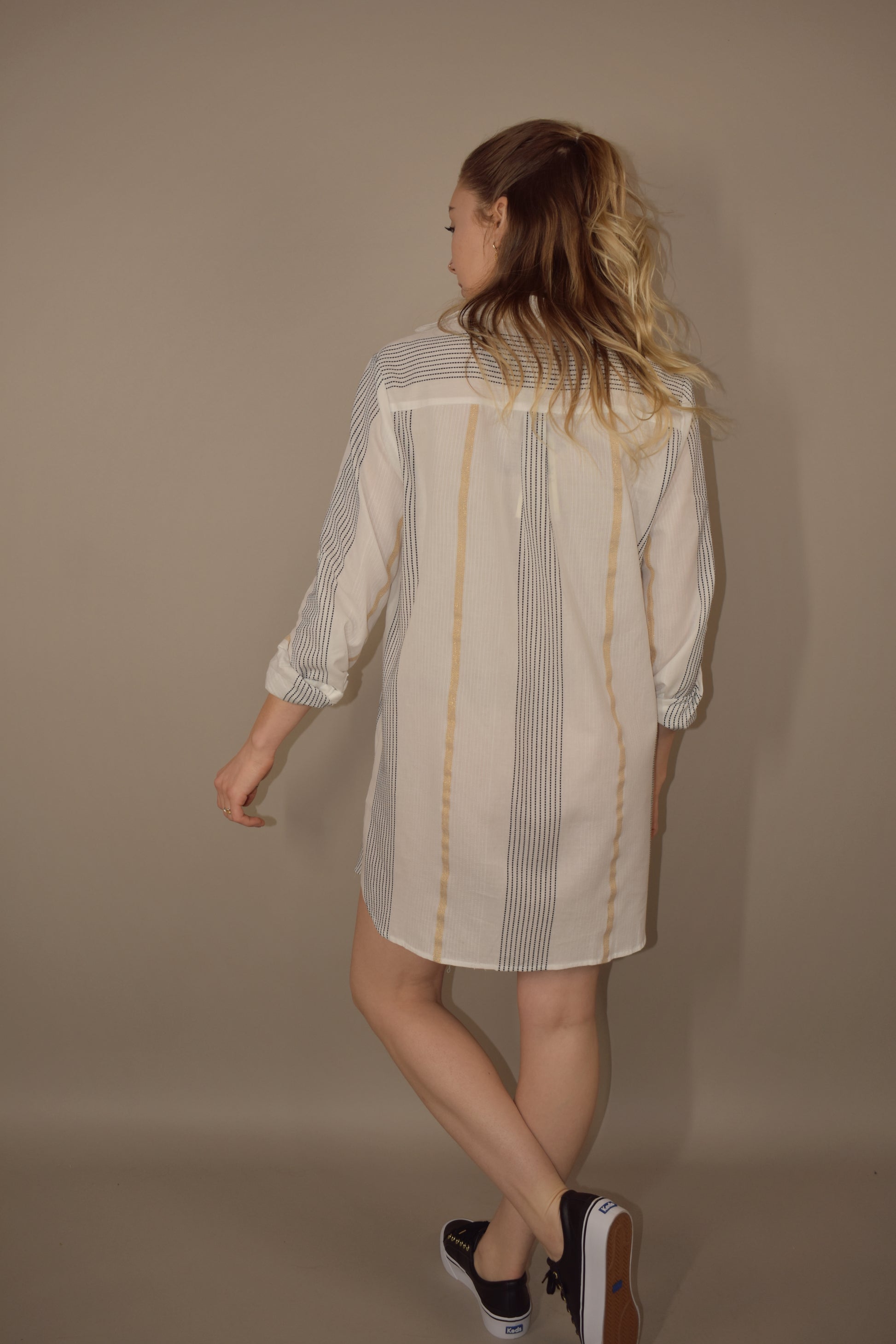 long sleeve mini shirt dress. white with taupe and black vertical stripes. pockets in front. collared and v neck. 