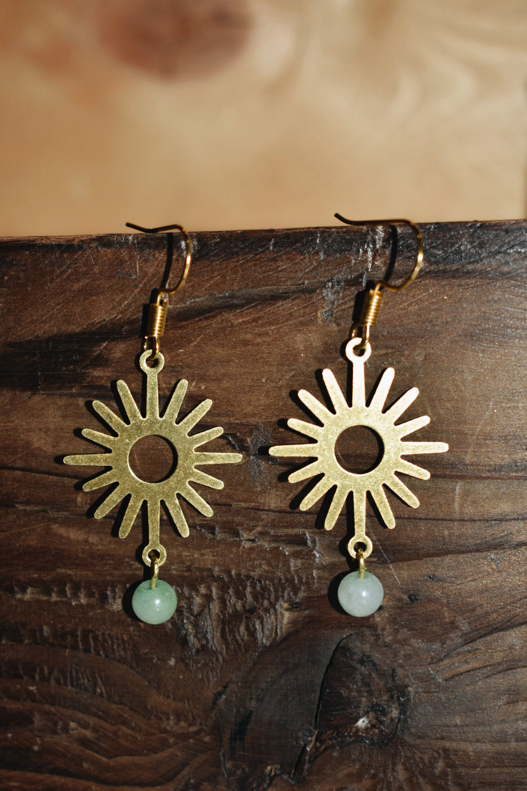 green aventurine beads with a raw brass sun pendant gold earrings
