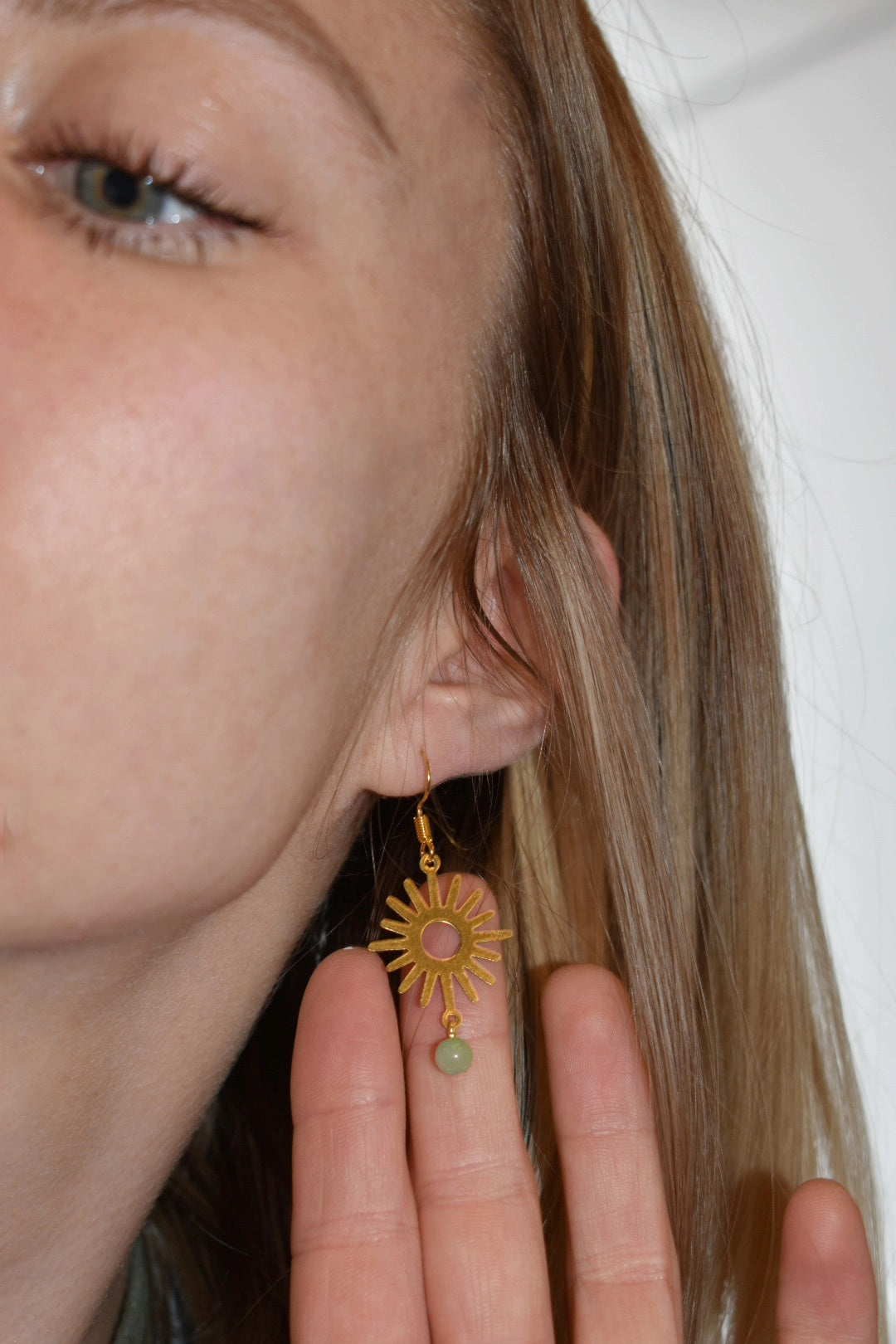 green aventurine beads with a raw brass sun pendant gold earrings