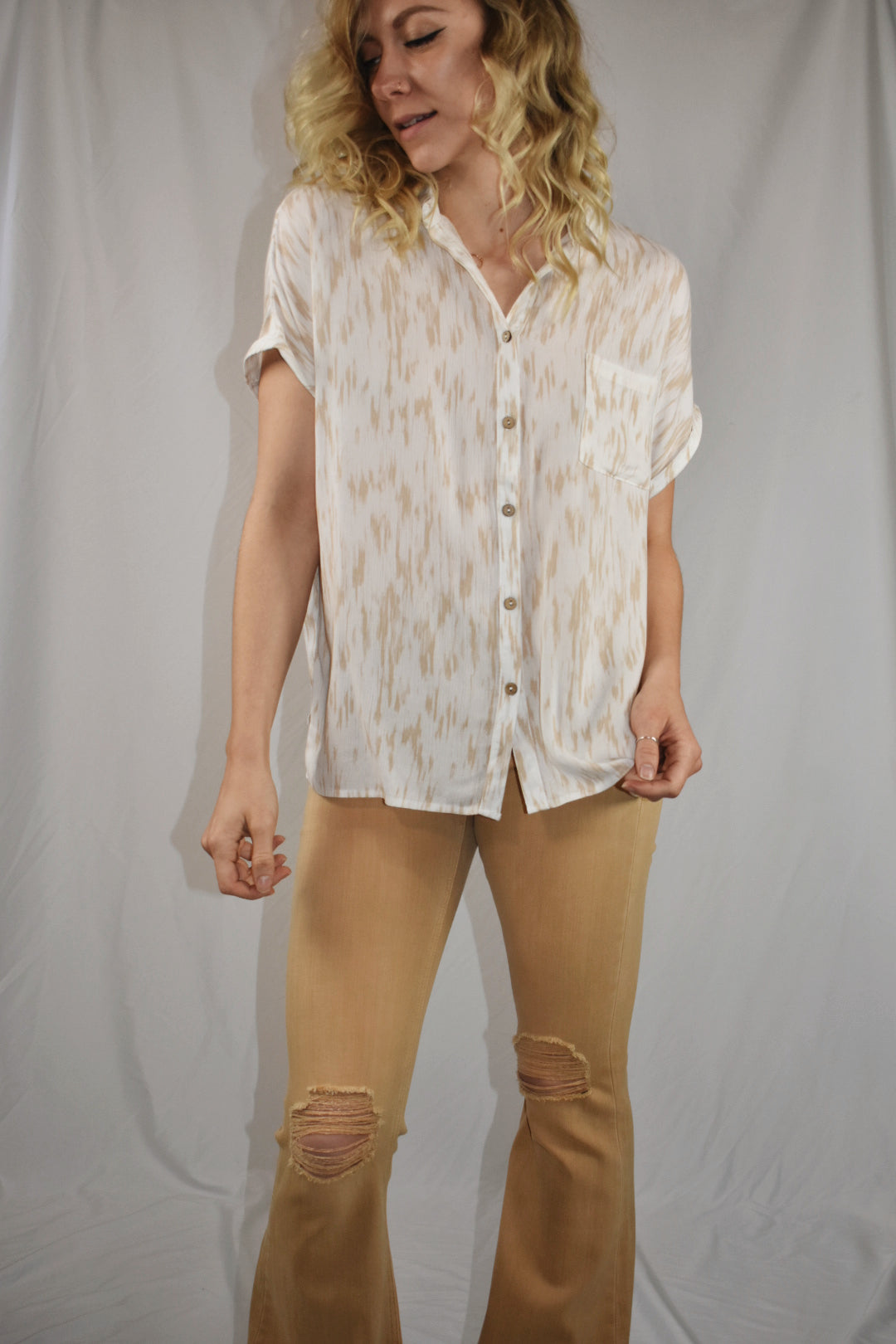white and tan patterned short sleeve button down with cuffed sleeves slits on side one breast pocket beachy mittoshop the revival