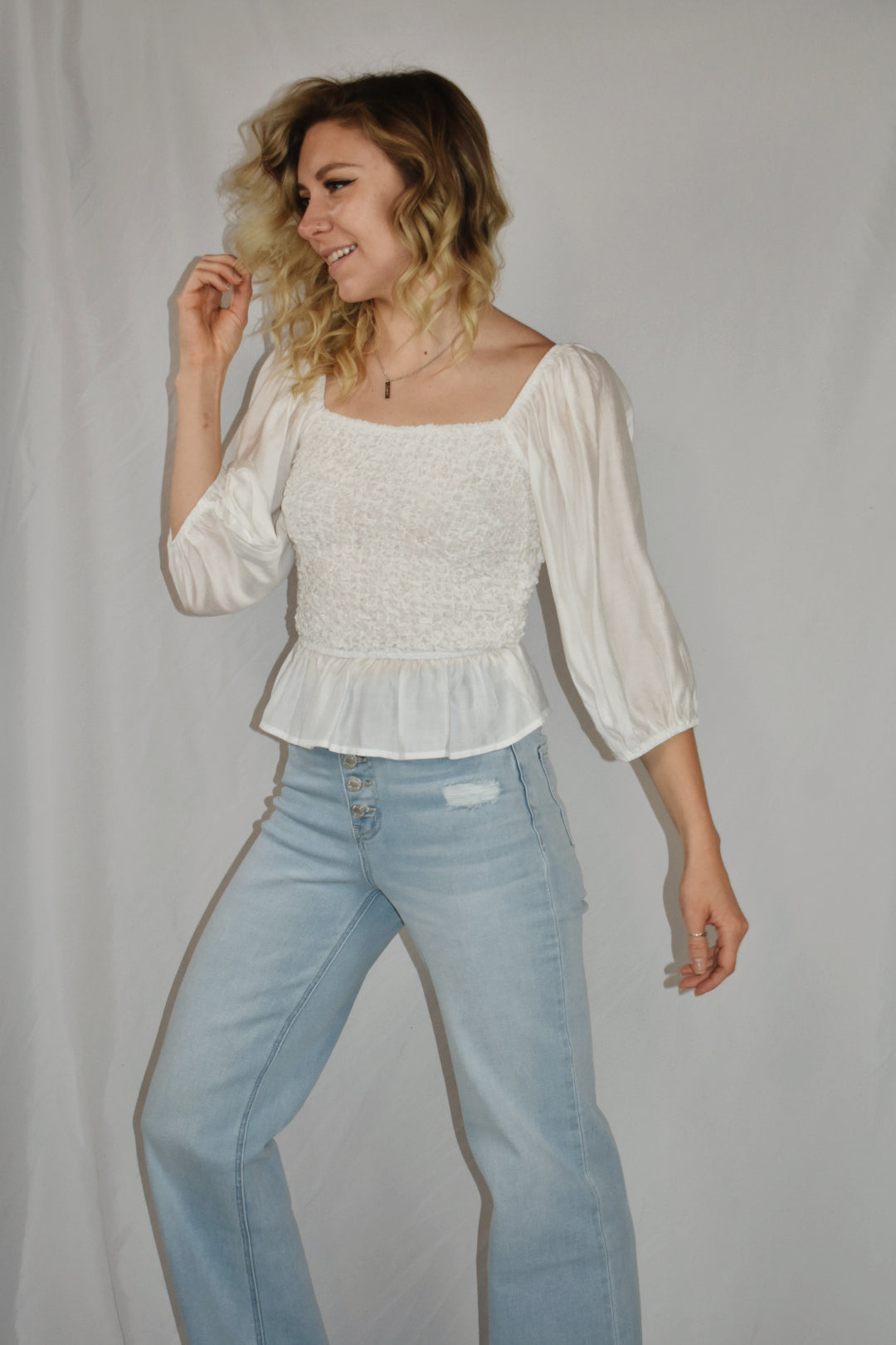 white blouse square neckline 3/4 length sleeves popcorn smocking detail on the bodice ruffle bottom mittoshop the revival