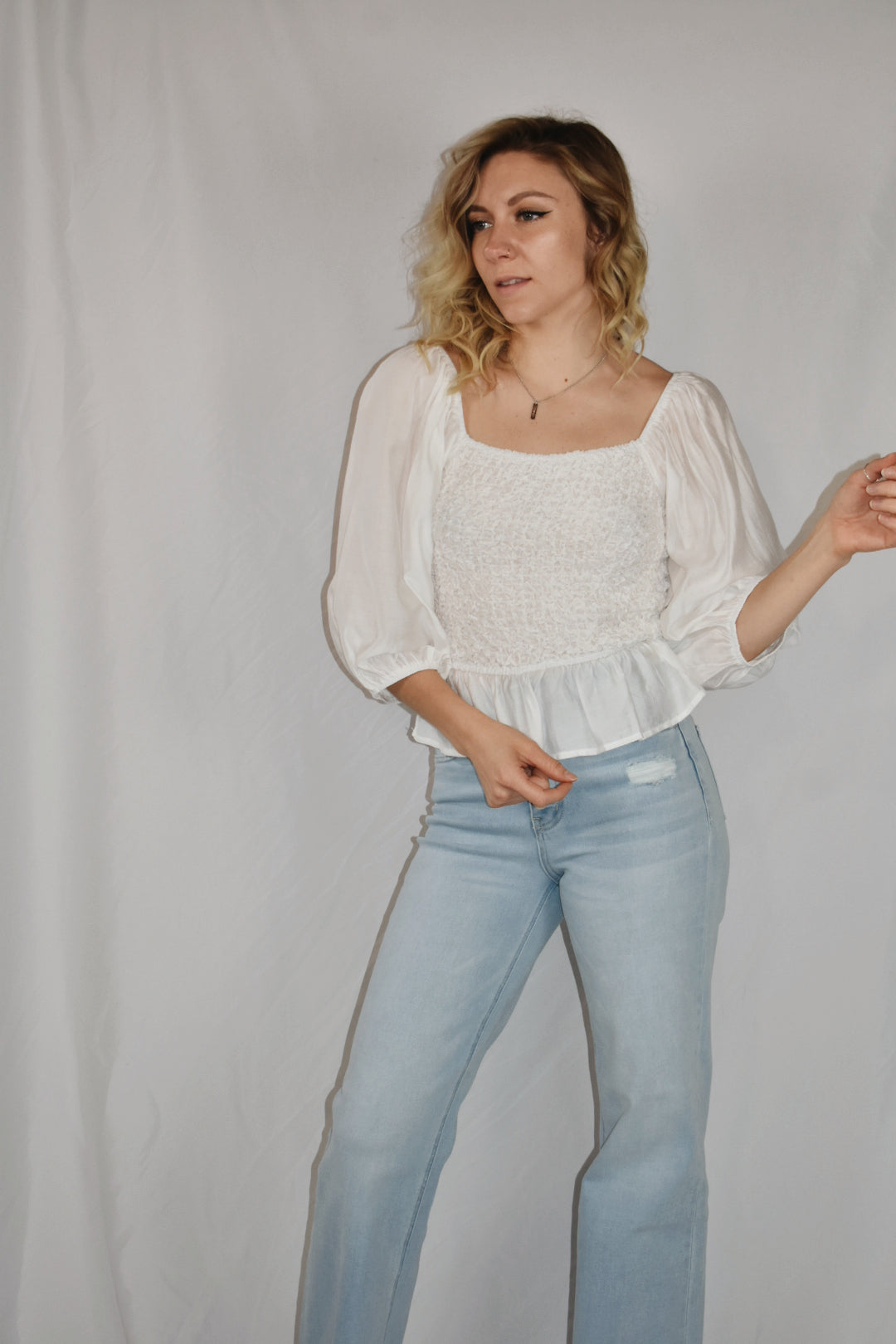 white blouse square neckline 3/4 length sleeves popcorn smocking detail on the bodice ruffle bottom mittoshop the revival