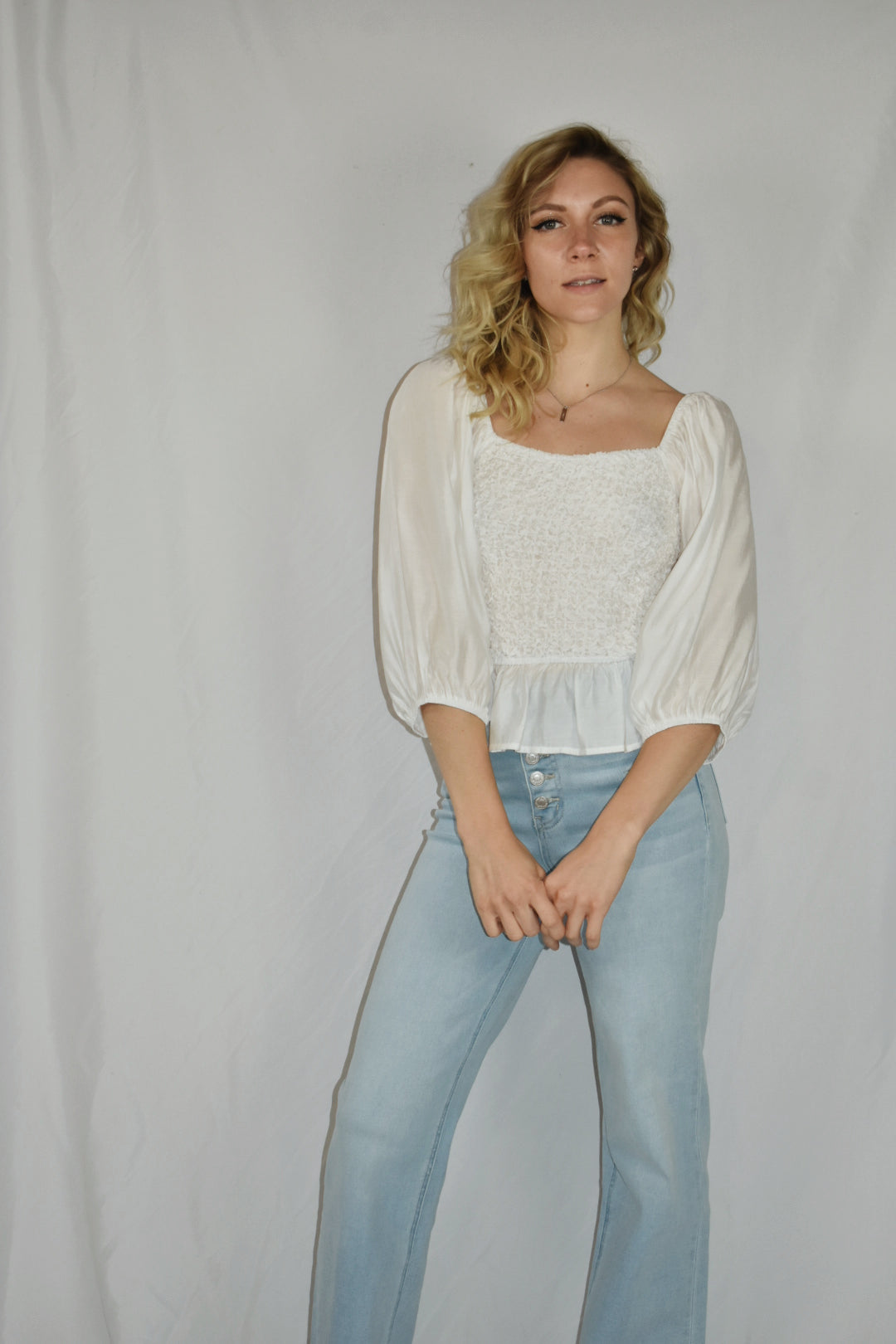 white blouse square neckline 3/4 length sleeves popcorn smocking detail on the bodice ruffle bottom mittoshop the revival