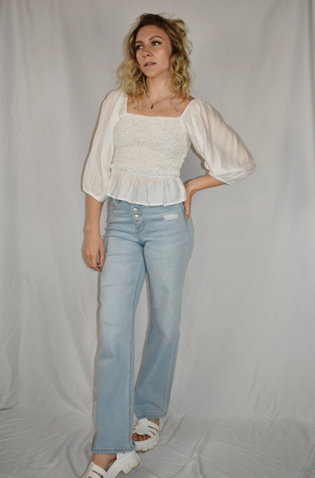 white blouse square neckline 3/4 length sleeves popcorn smocking detail on the bodice ruffle bottom mittoshop the revival