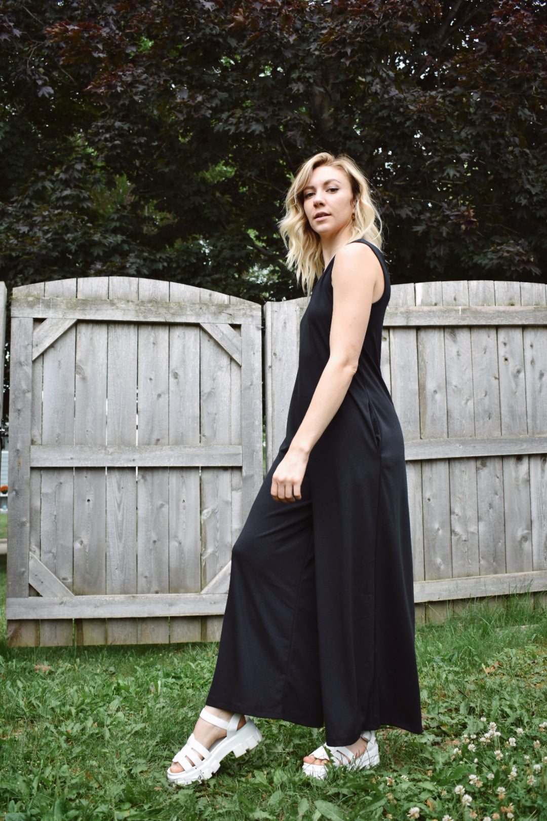 scoop neck tank jumpsuit in black with wide legs and pockets. Made with french terry knit fabric and is loose fitting. The brand is Mittoshop.