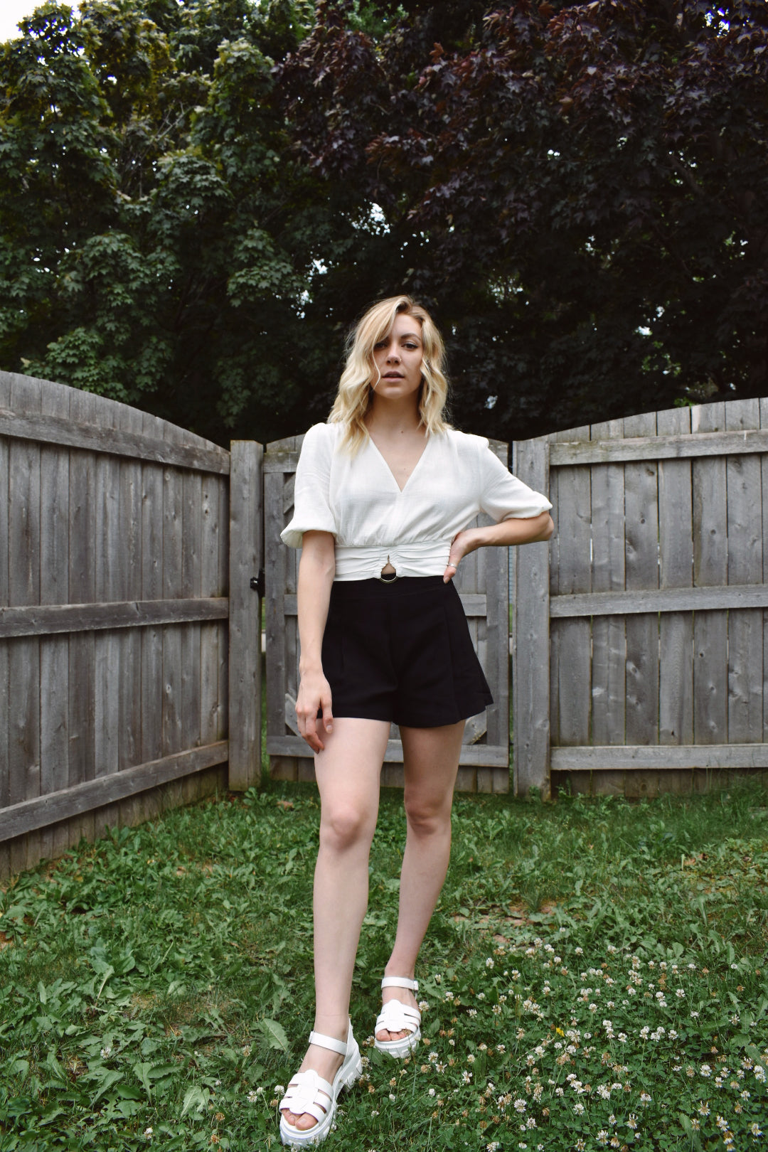 High waisted black pleated dress shorts with zipper enclosure on side fitted band on top. The brand is Mittoshop.