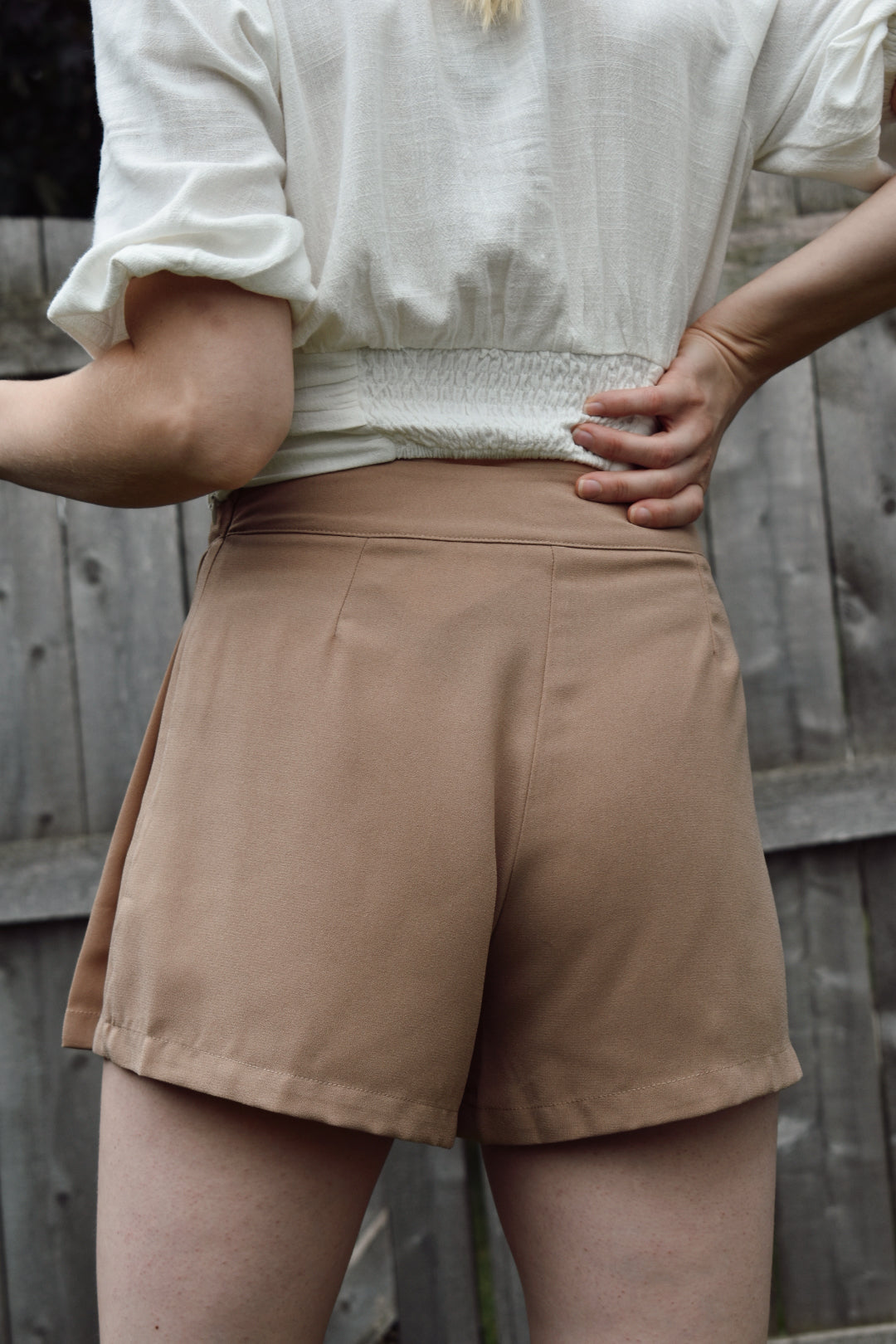 High waisted mocha pleated dress shorts with zipper enclosure on side fitted band on top. The brand is Mittoshop.