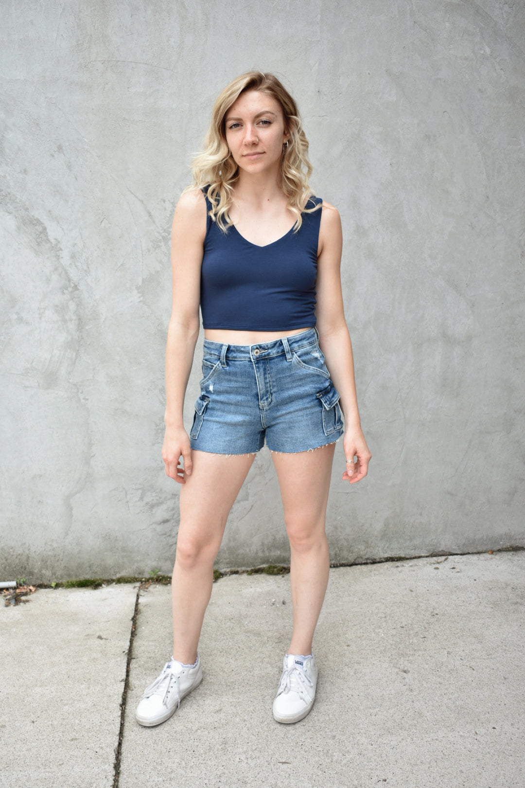 Navy double layered fabric cropped tank. V neck in front, scooped in back. The brand is Hyfve.