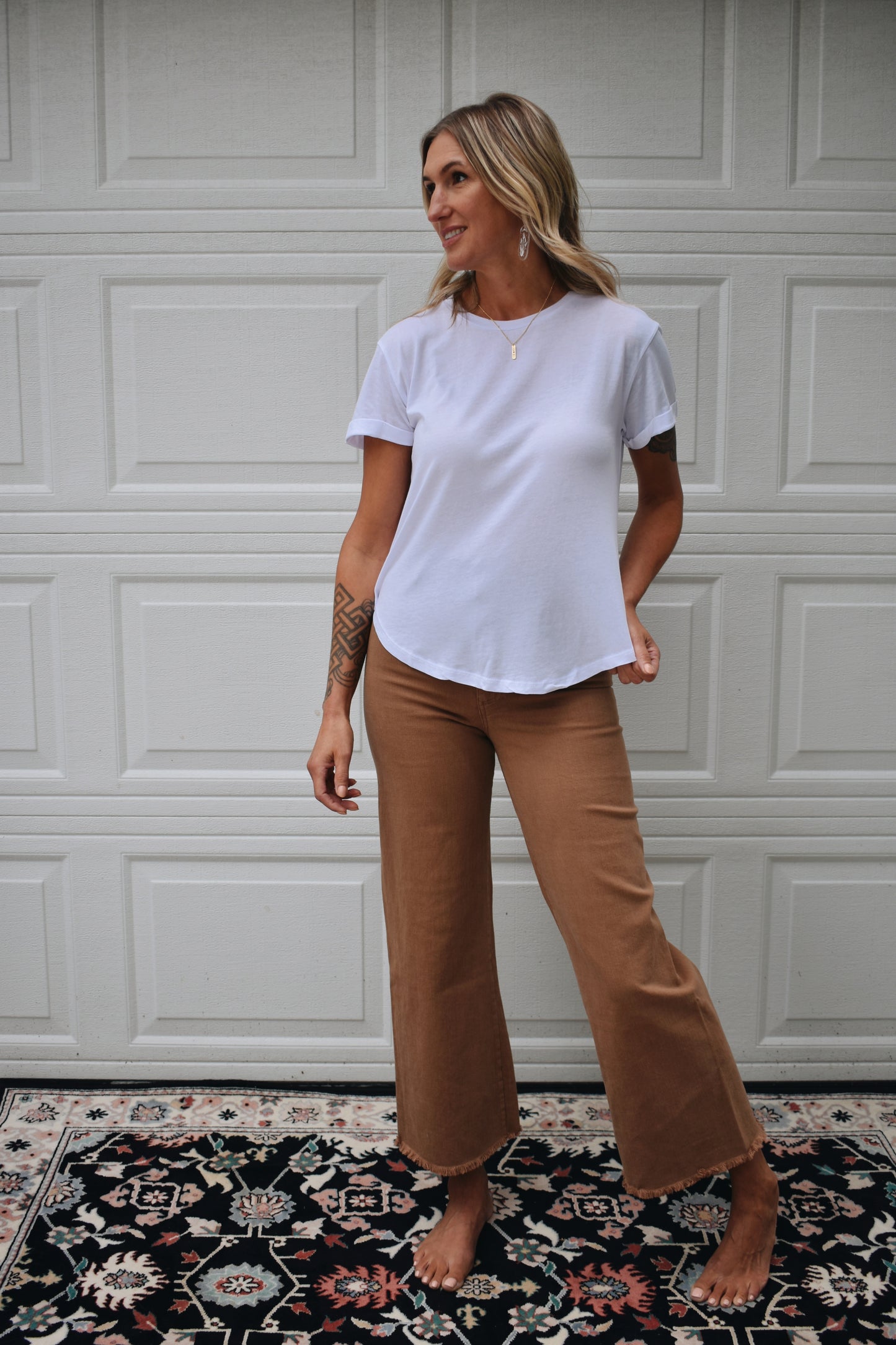 loose fitted white tee with cuffed sleeves and round neckline. super soft fabric. full length.