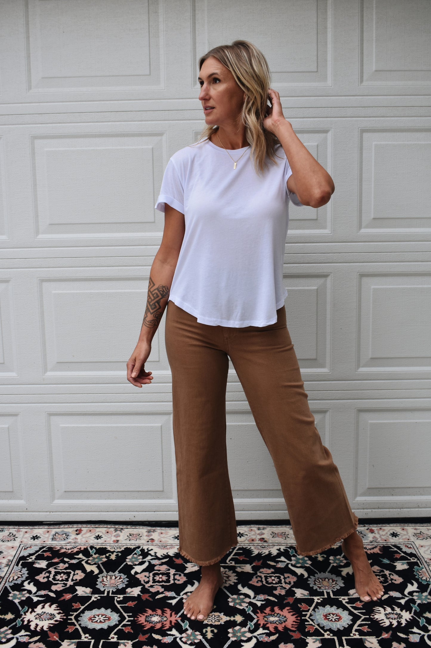 loose fitted white tee with cuffed sleeves and round neckline. super soft fabric. full length.