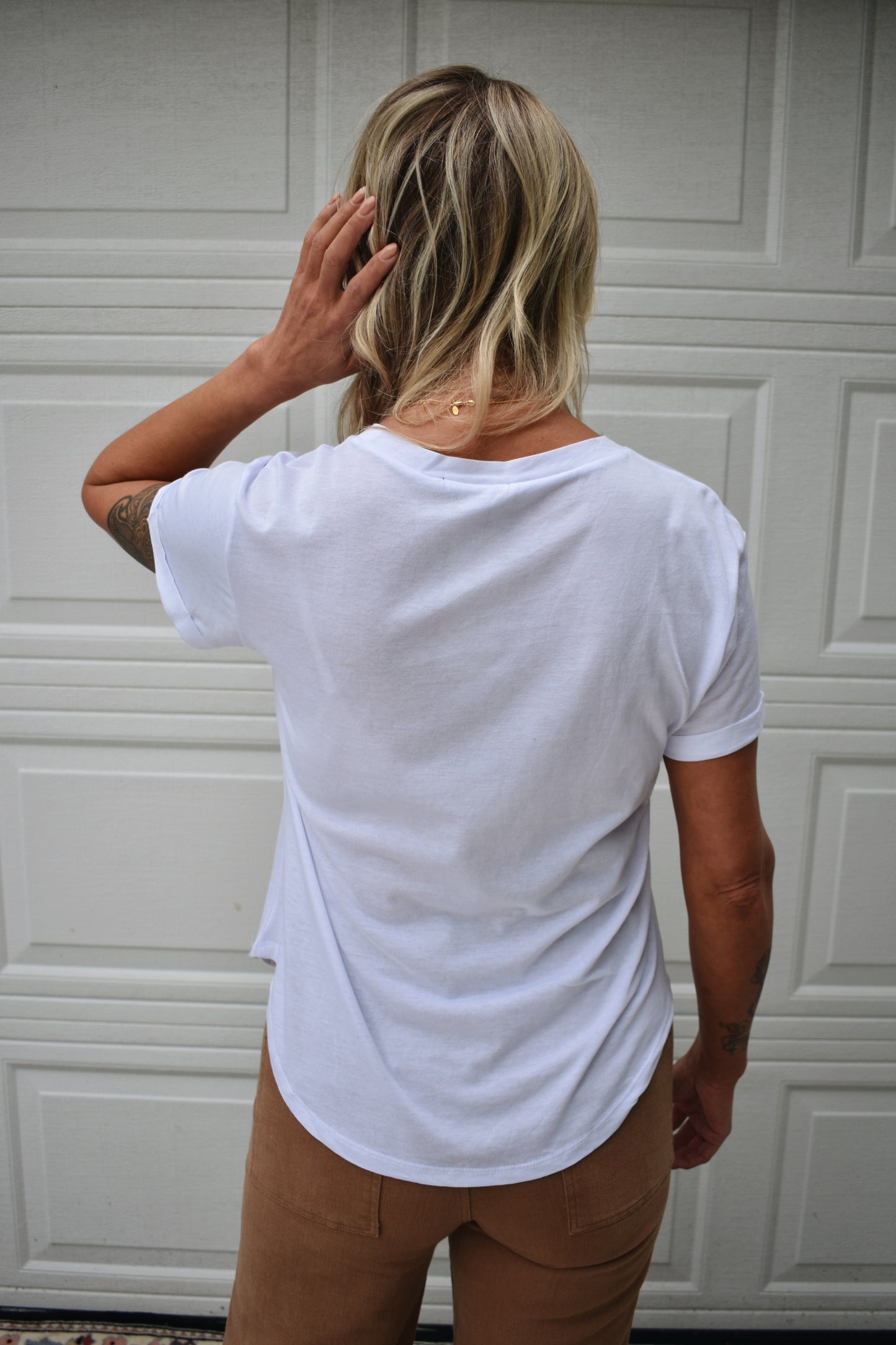 loose fitted white tee with cuffed sleeves and round neckline. super soft fabric. full length.