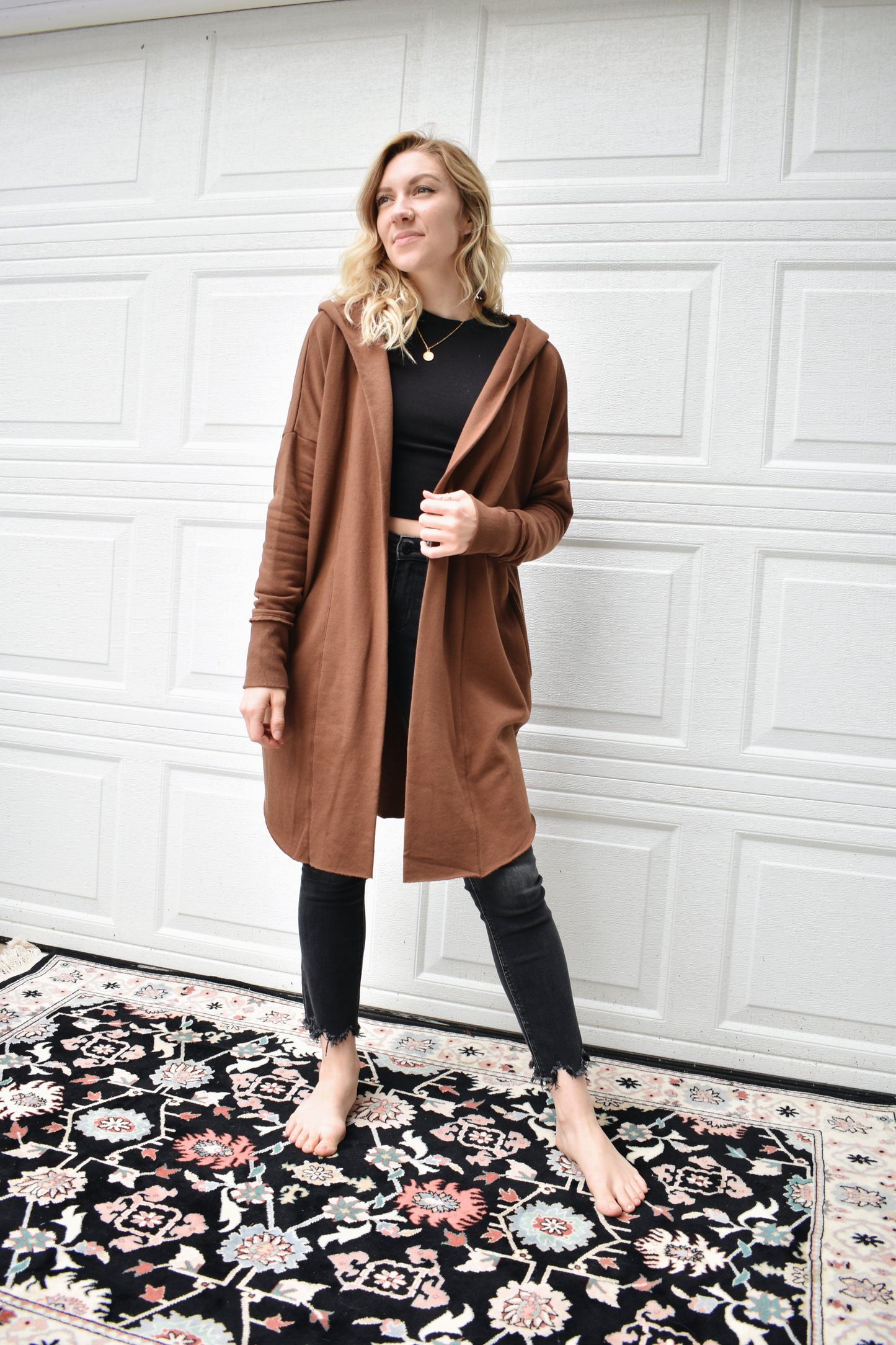Cocoa colored hooded jersey cardigan with wide cuffed sleeves, an open front, and pockets. fleece lining. 100% cotton