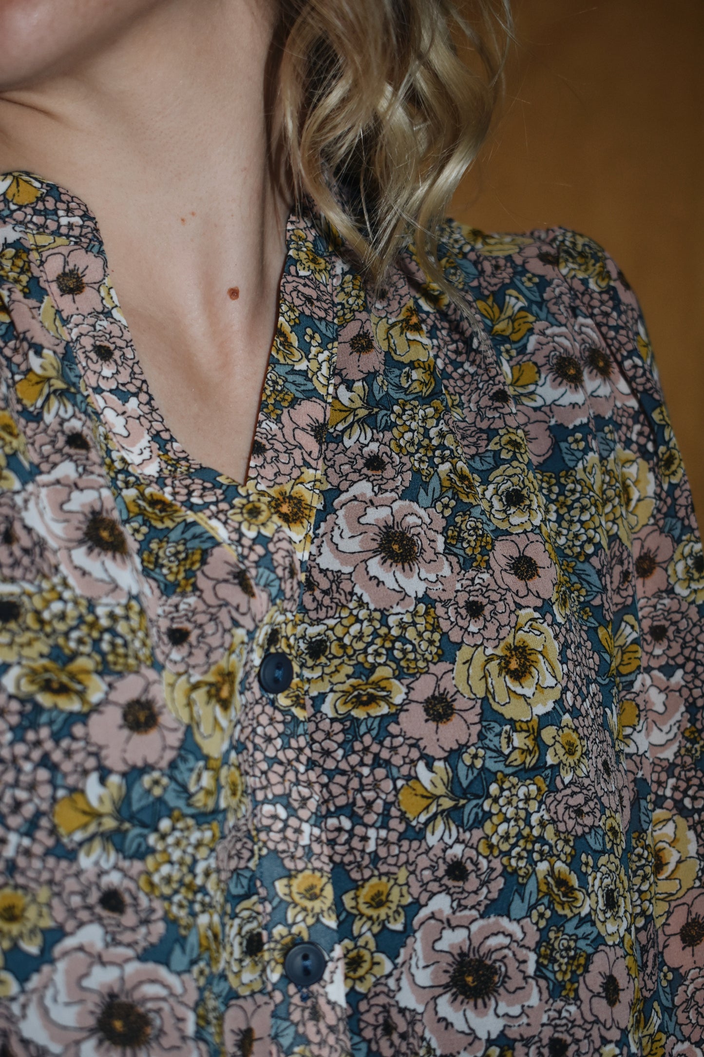 long sleeve mini dress loose fitted, vintage floral pattern, round neckline, slit front and placket with button front closure. ruffle tier skirt