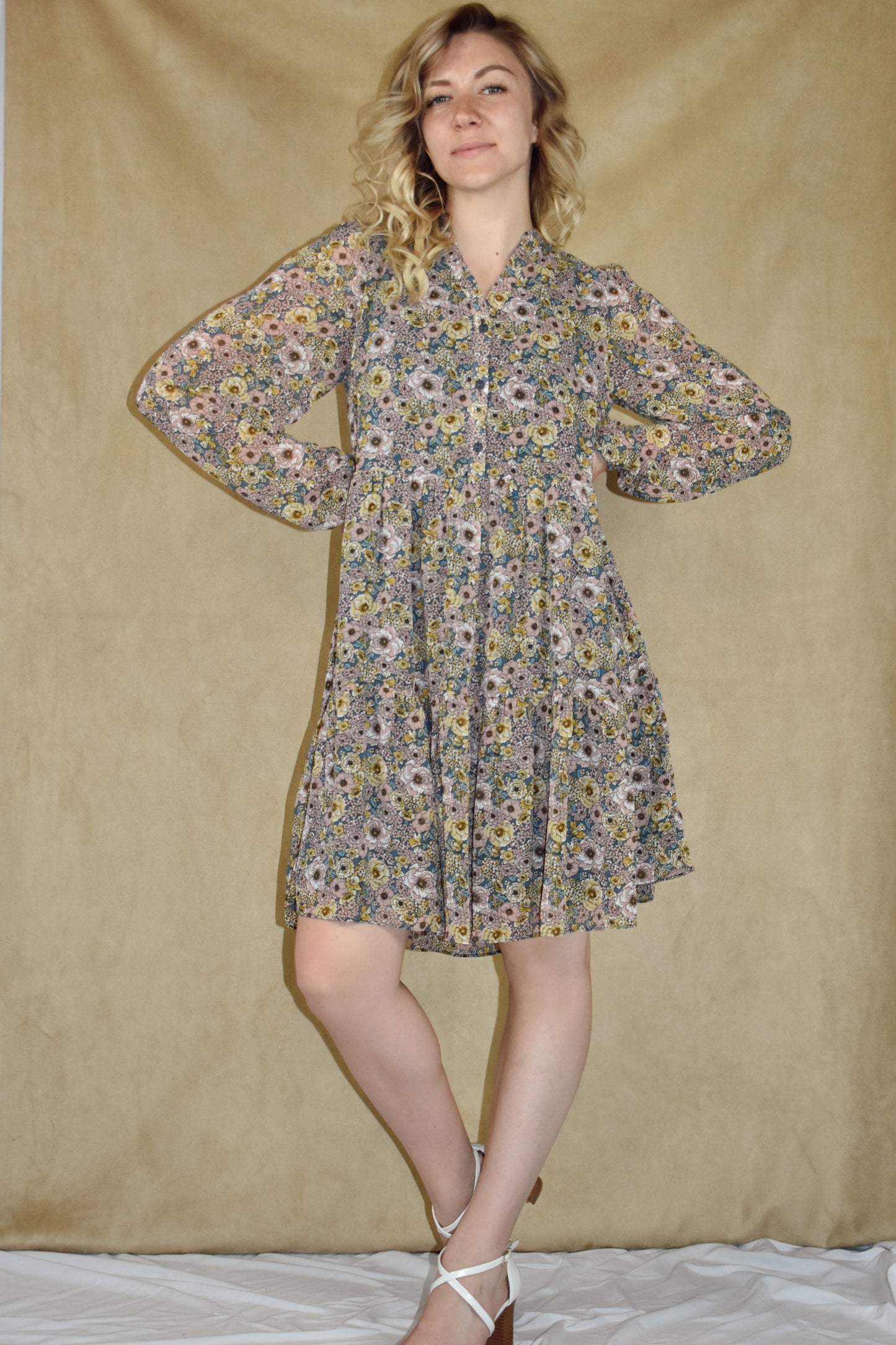 long sleeve mini dress loose fitted, vintage floral pattern, round neckline, slit front and placket with button front closure. ruffle tier skirt