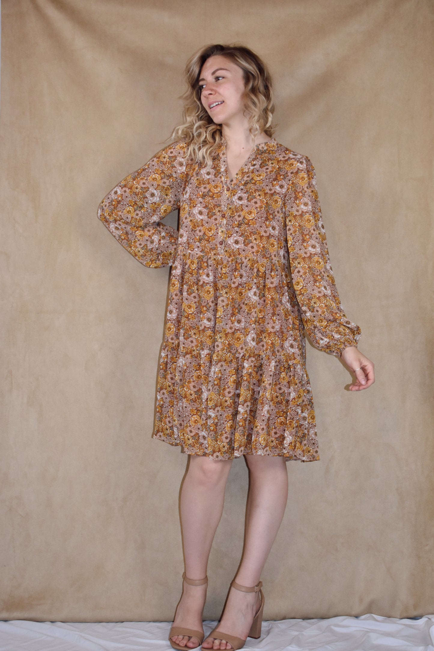 long sleeve mini dress loose fitted, vintage floral pattern, round neckline, slit front and placket with button front closure. ruffle tier skirt