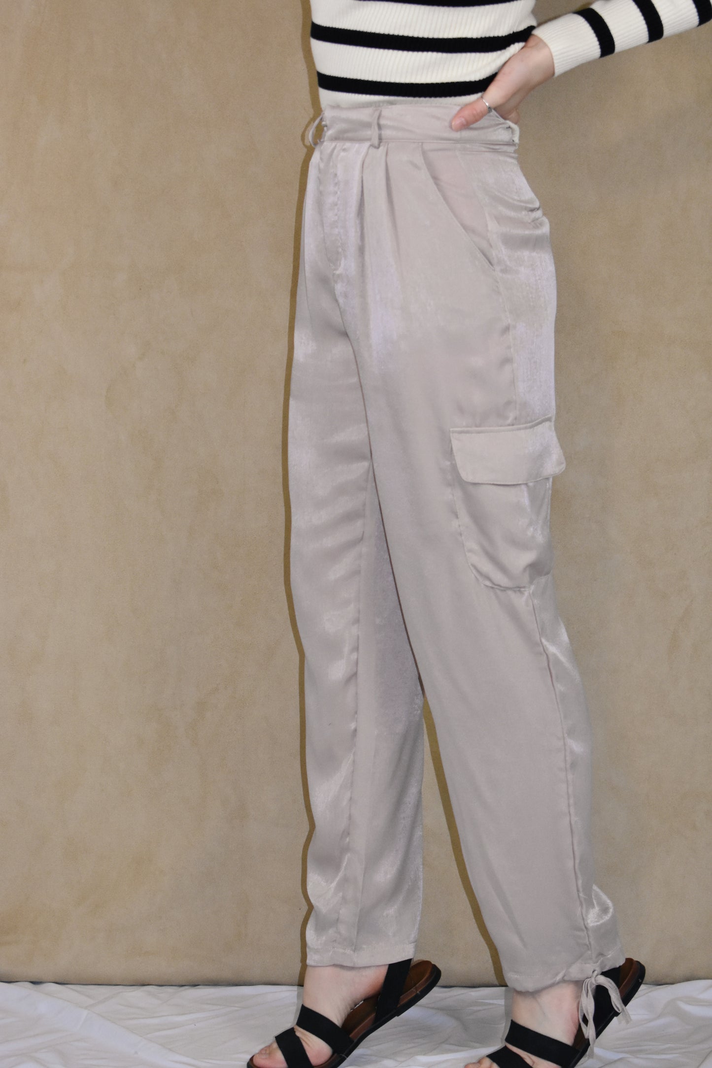 dusty rose satin cargo pants. side pockets with top flap and drawstring on the bottom.