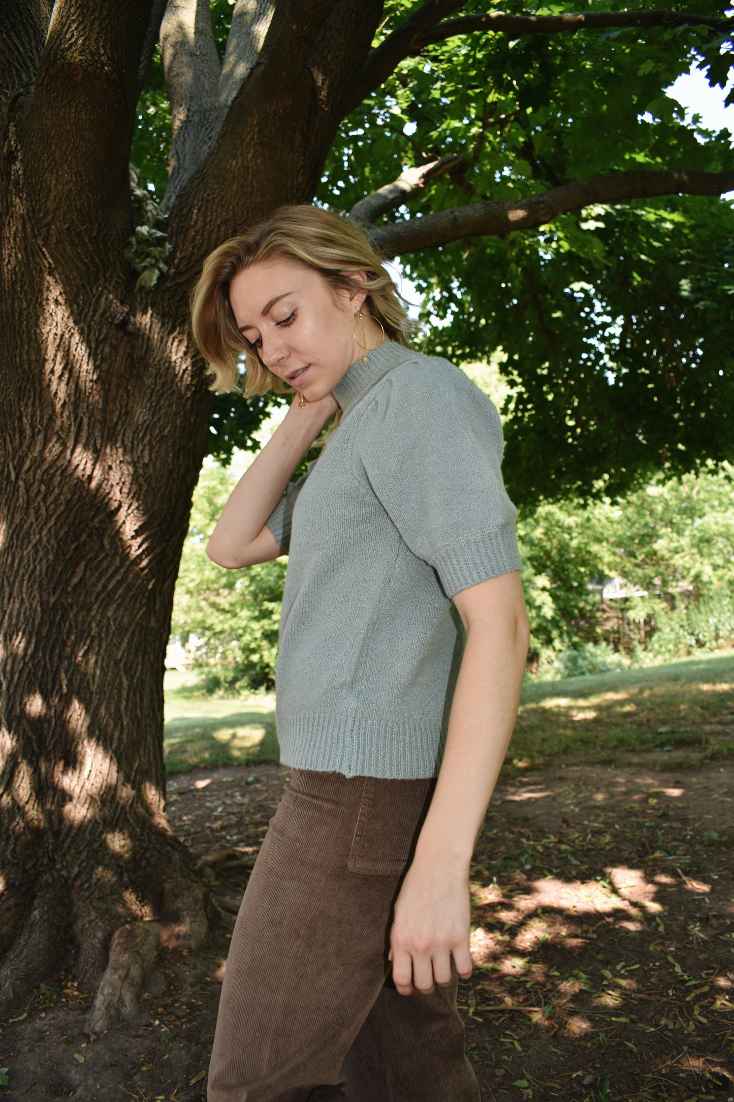 light blue mod neck short puff sleeve sweater with a tailored fit with a ribbed neck and cuffs. Sleeves hit just above the elbow.