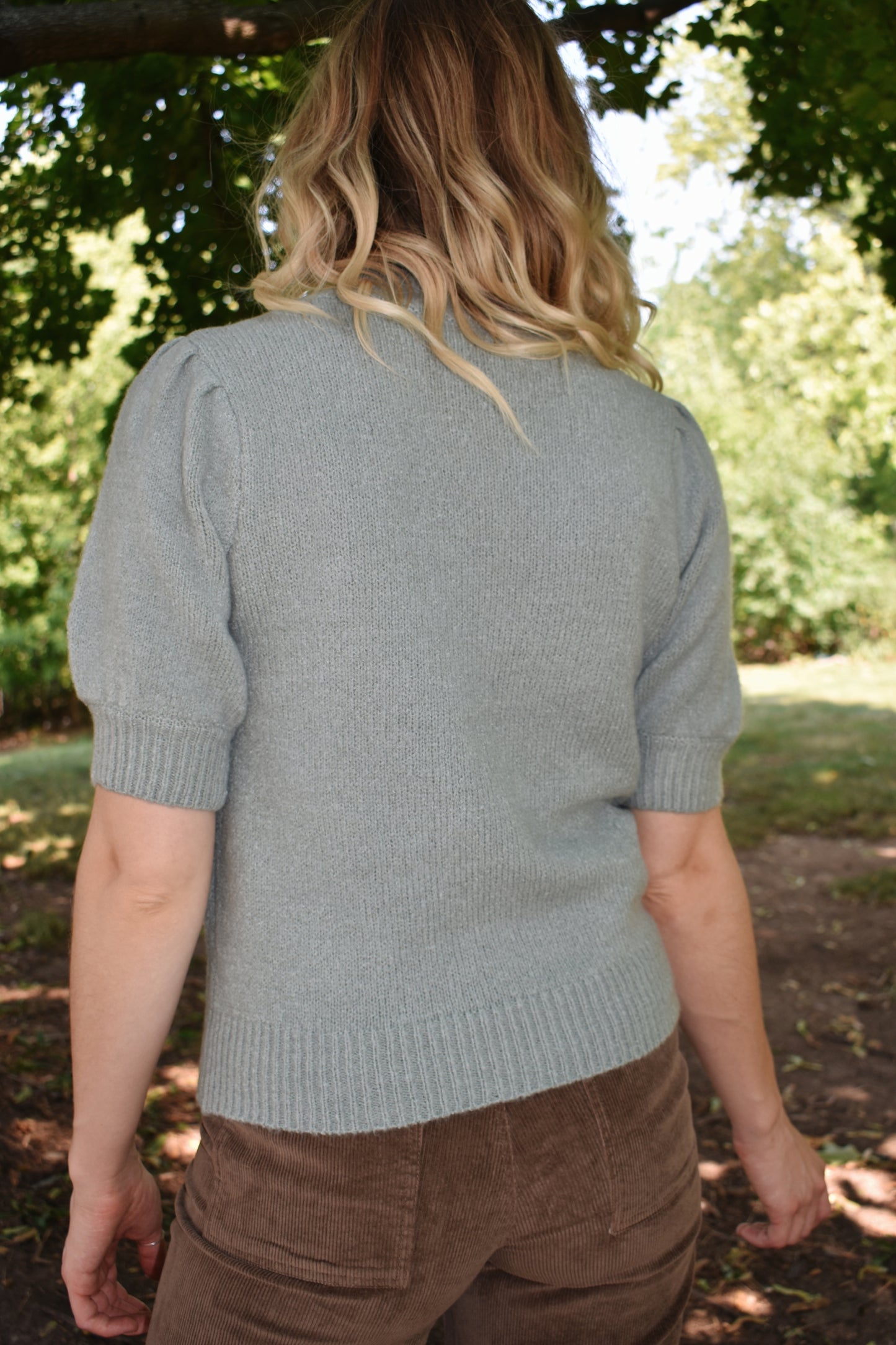 light blue mod neck short puff sleeve sweater with a tailored fit with a ribbed neck and cuffs. Sleeves hit just above the elbow.
