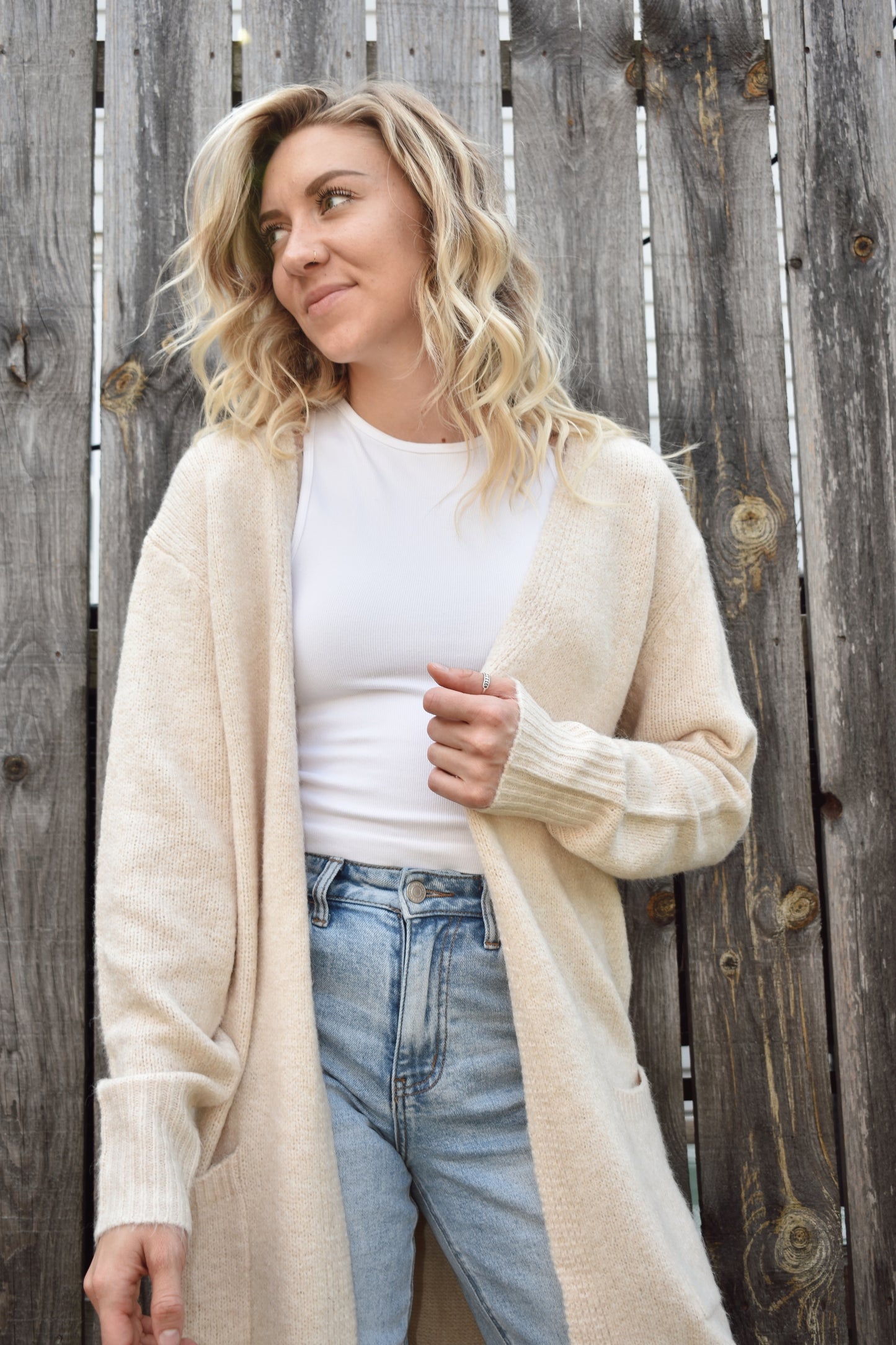 Open front knit cardigan in a natural color hits just above the knees and has two front patch pockets super cozy