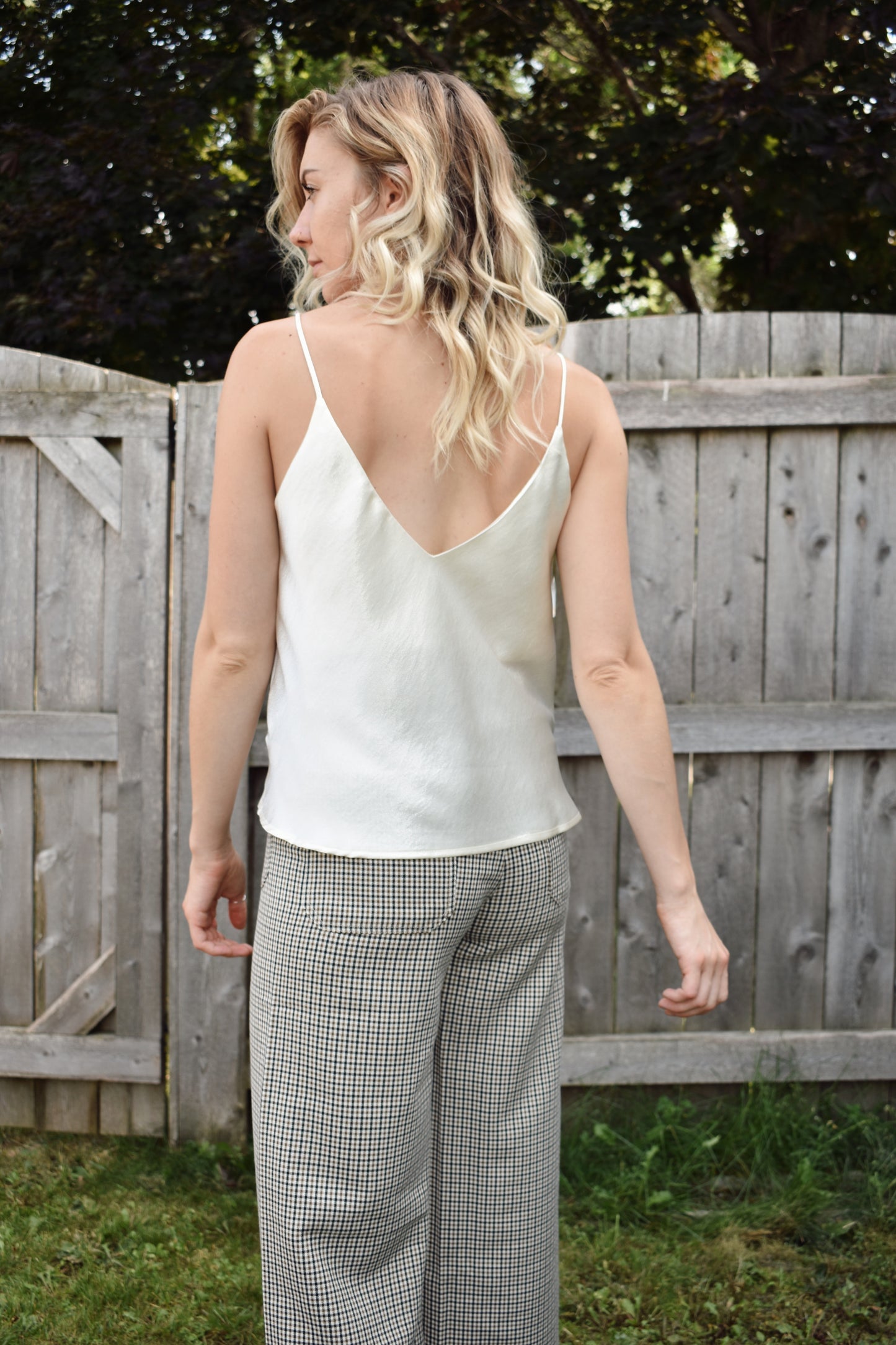 Ivory metallic sheen full length cami with adjustable spaghetti straps and a V neckline in the front and in the back