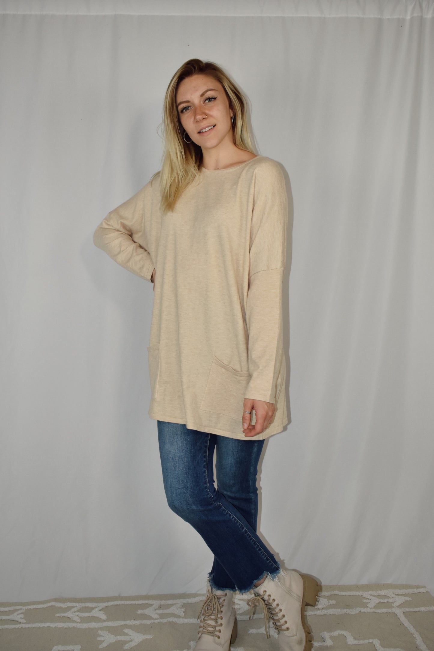 Oversized oatmeal colored sweater, lightweight fabric, scoop neck, front patch pockets, drop shoulders.