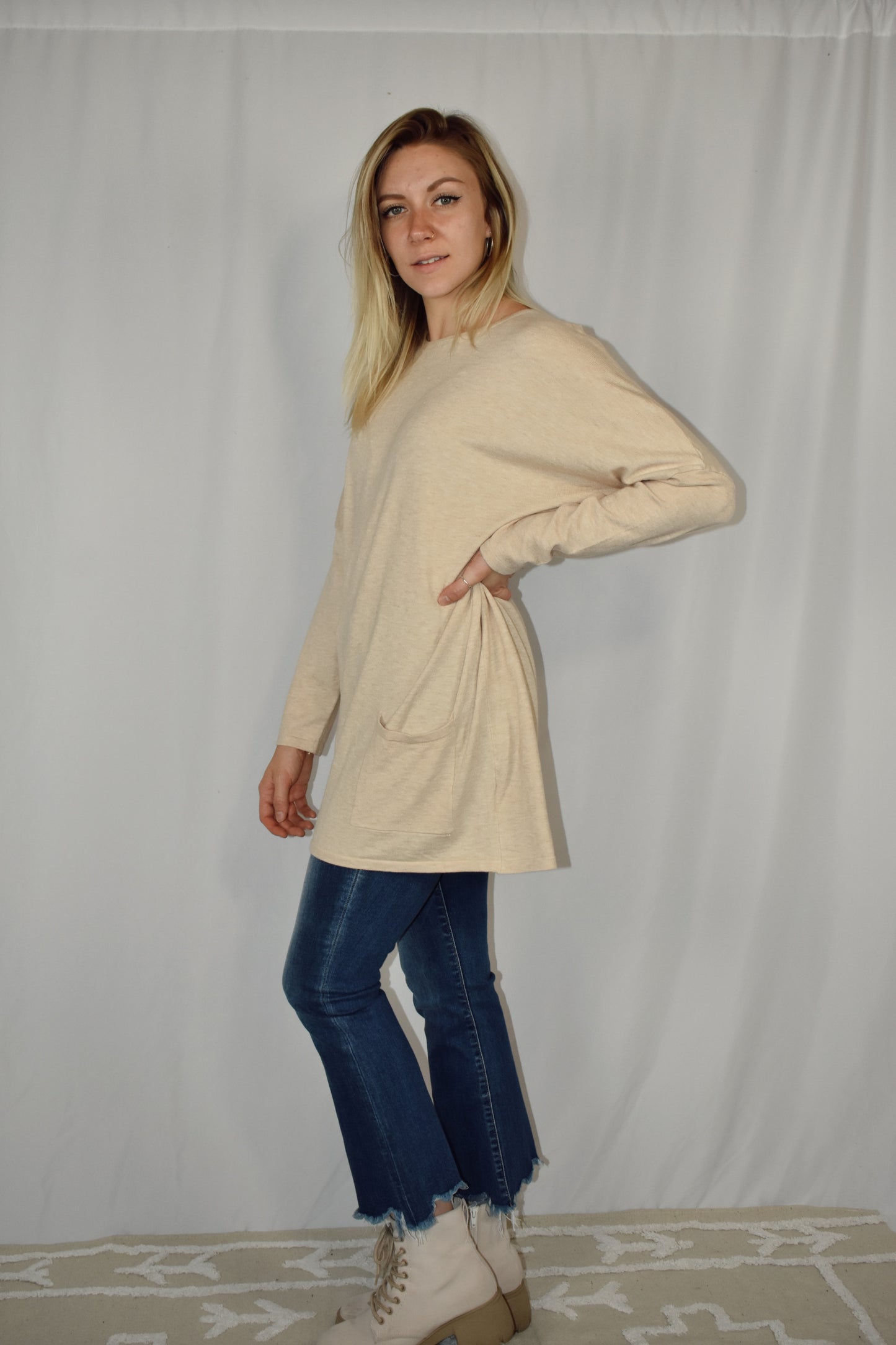 Oversized oatmeal colored sweater, lightweight fabric, scoop neck, front patch pockets, drop shoulders.