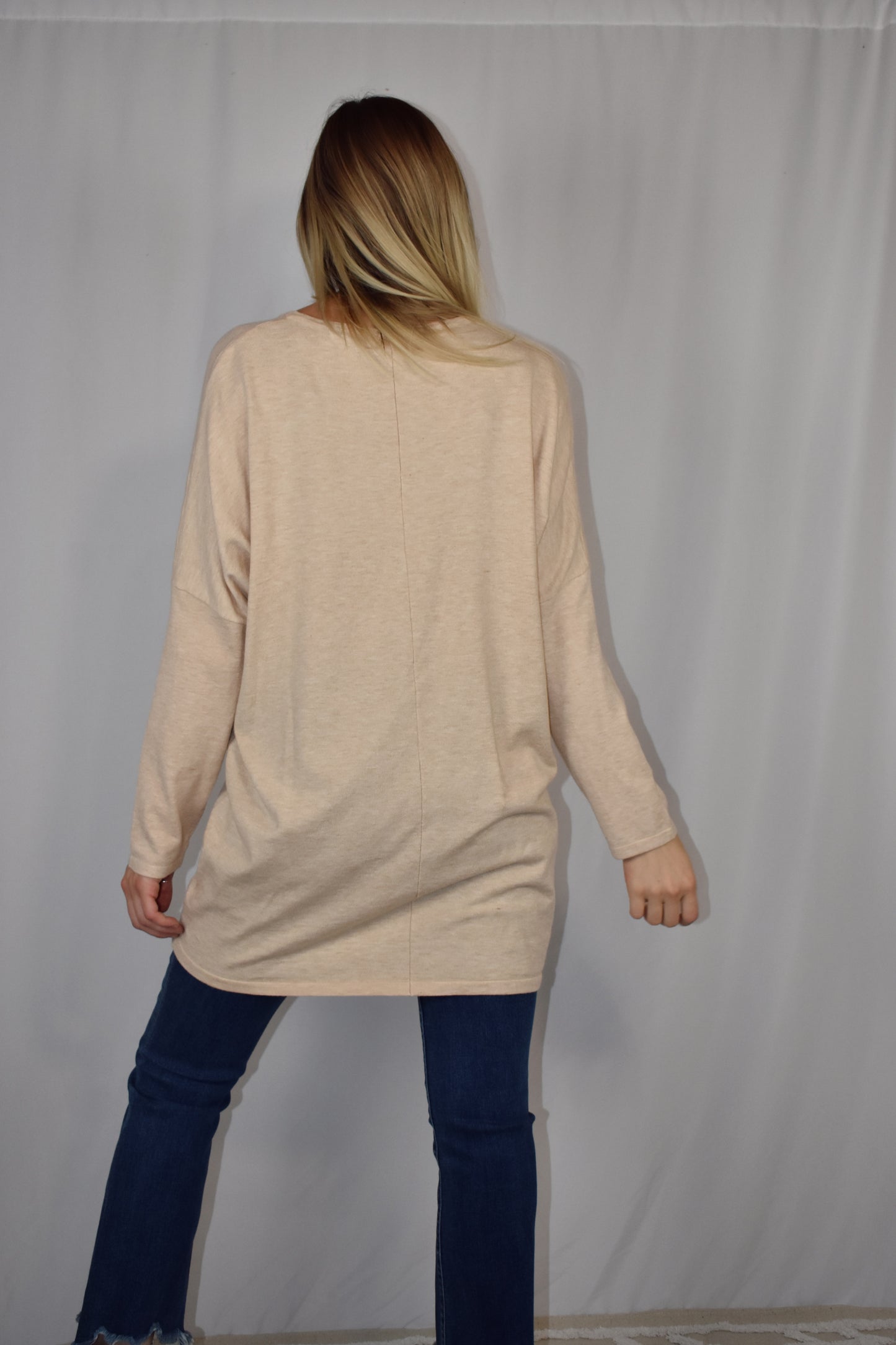 Oversized oatmeal colored sweater, lightweight fabric, scoop neck, front patch pockets, drop shoulders.