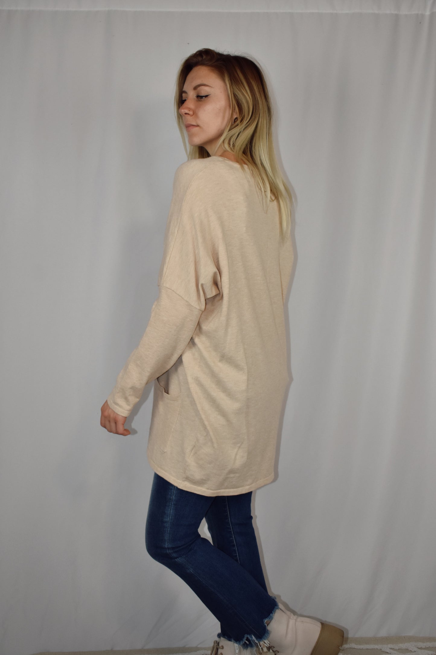 Oversized oatmeal colored sweater, lightweight fabric, scoop neck, front patch pockets, drop shoulders.