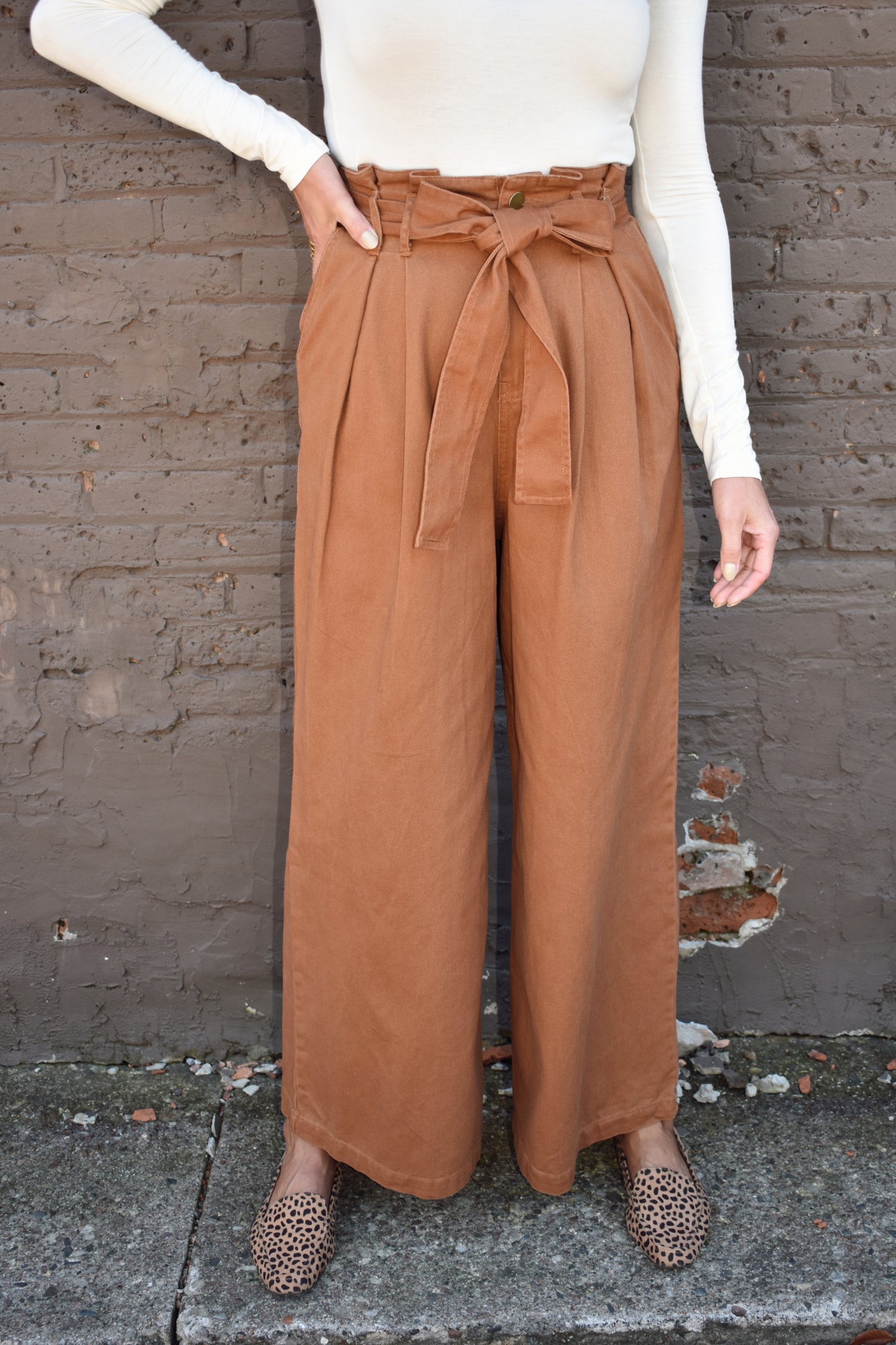 Light brown high waisted twill pants with wide legs, tie belt, side pockets, paper bag style on waistline