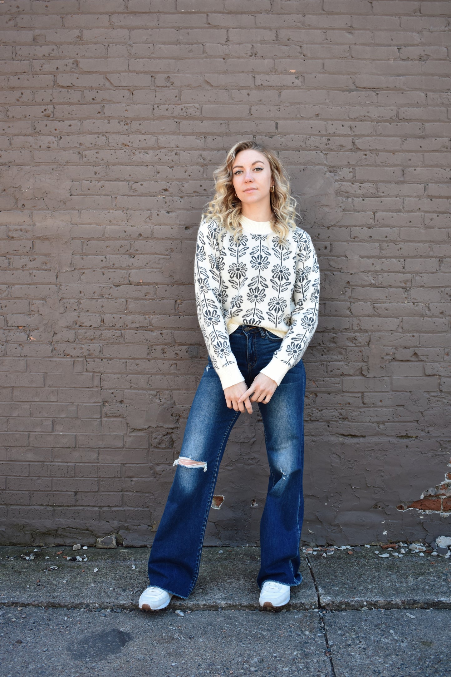 charcoal and cream floral pattern knit sweater with ribbed high round neckline, hem, and cuffs.