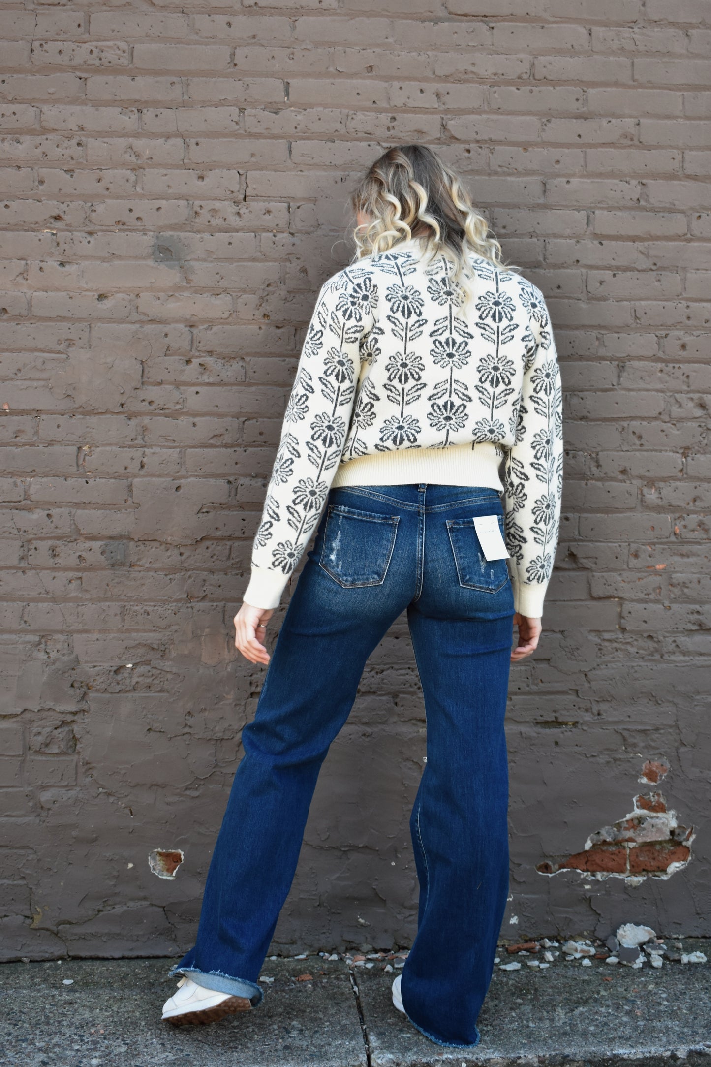 charcoal and cream floral pattern knit sweater with ribbed high round neckline, hem, and cuffs.