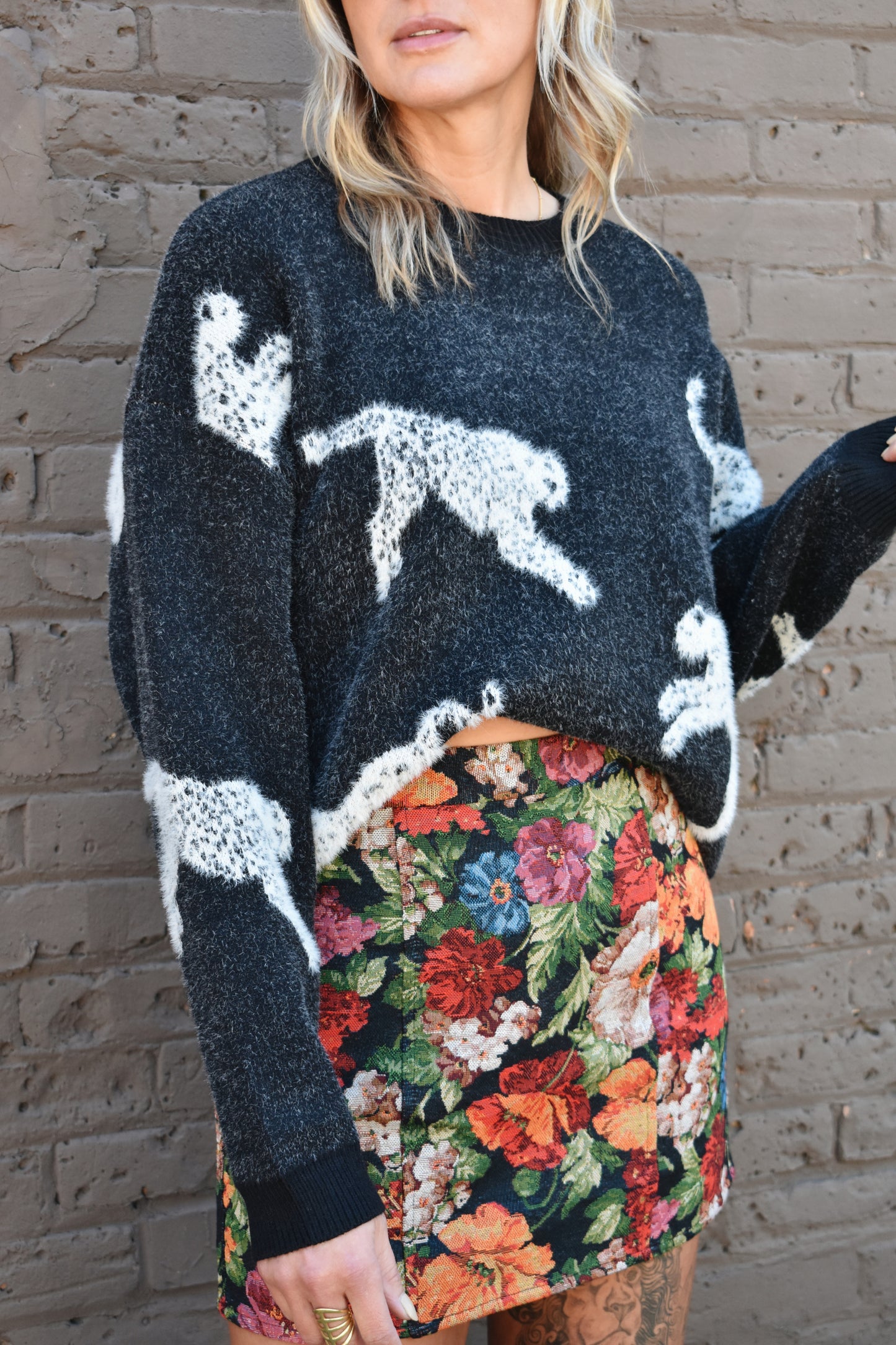 black long sleeve relaxed fit leopard body printed sweater with ribbed crewneck and cuffs. full length.
