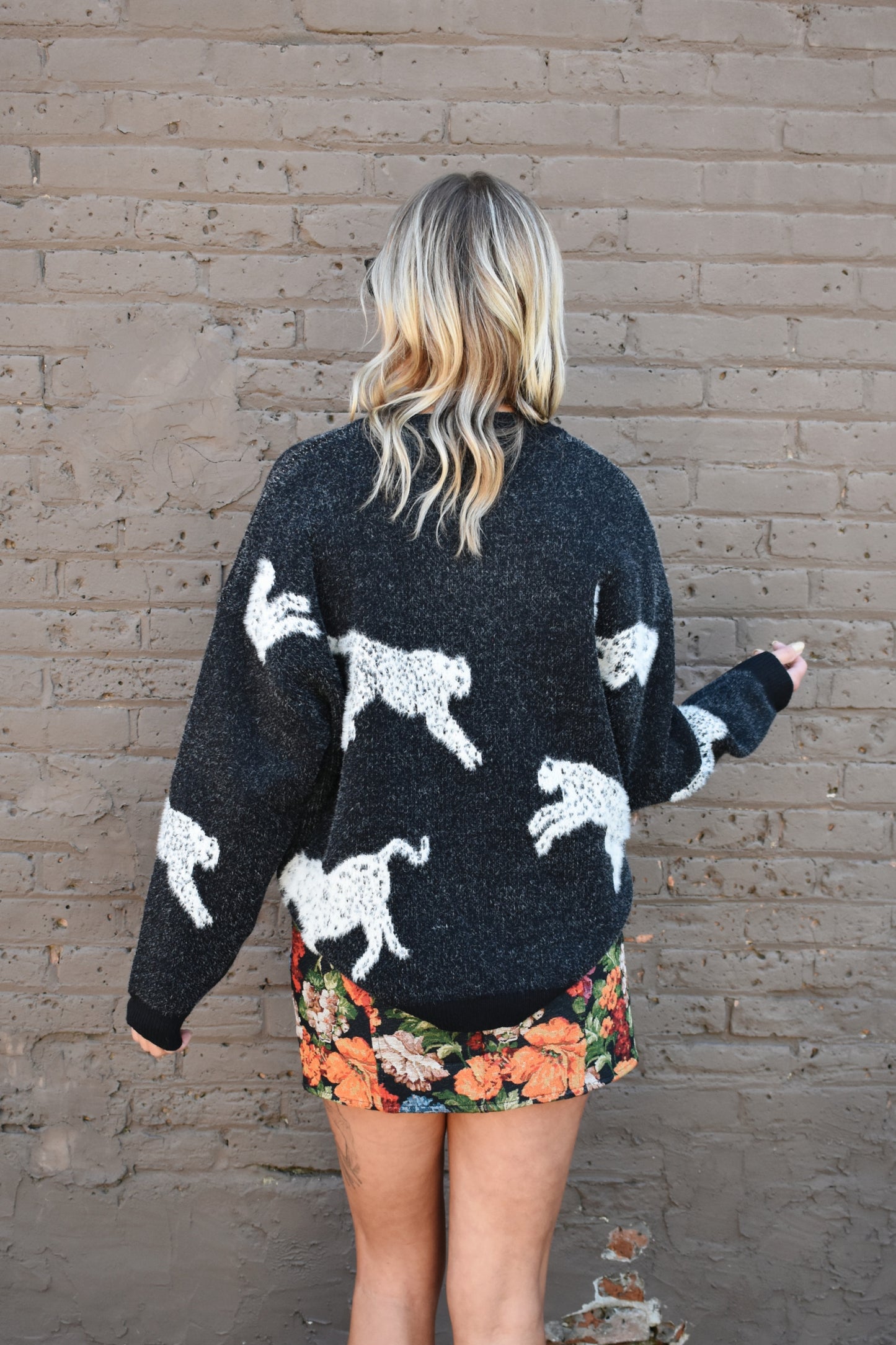 black long sleeve relaxed fit leopard body printed sweater with ribbed crewneck and cuffs. full length.
