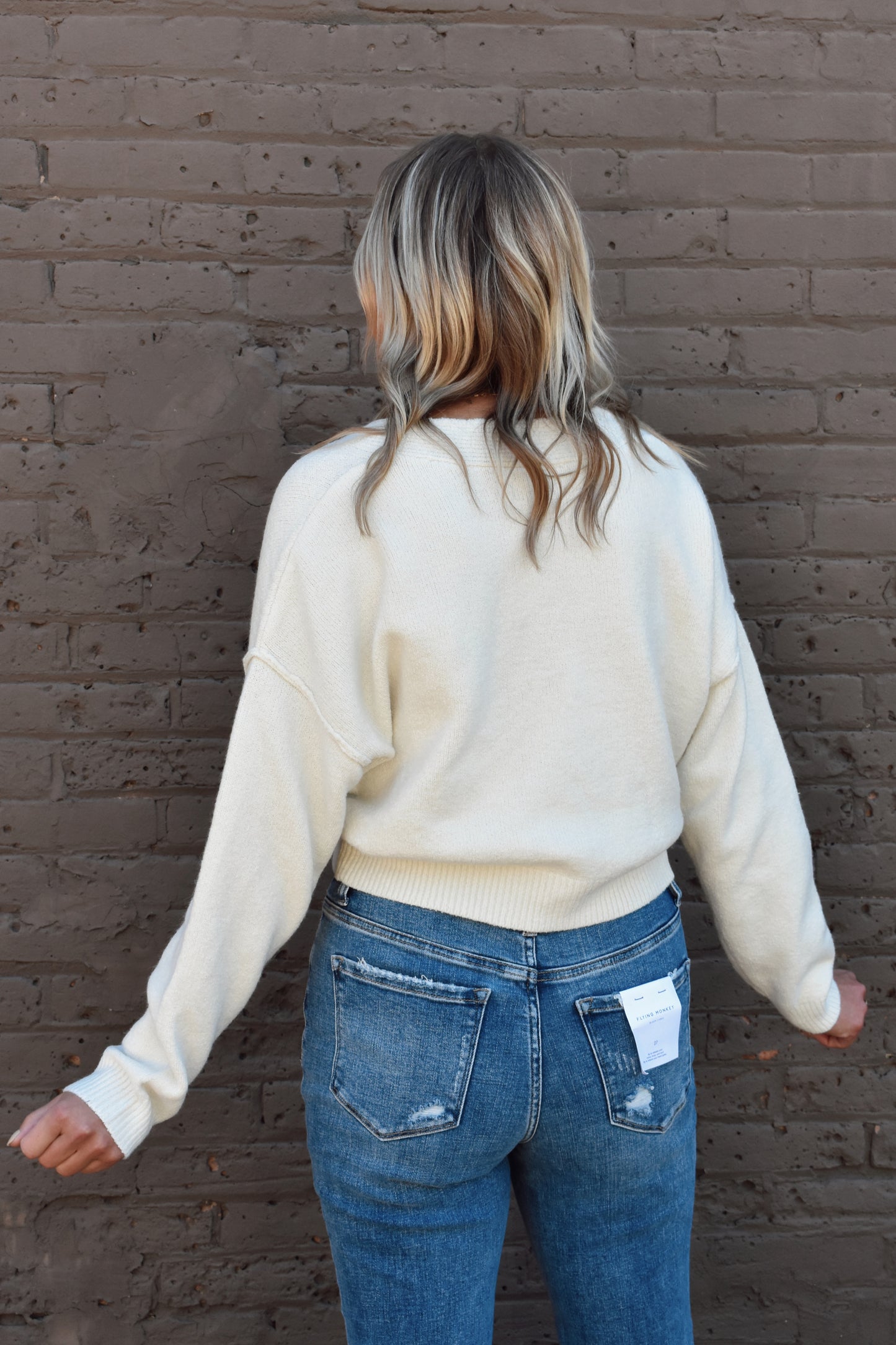 cropped v neck button front drop shoulder cardigan with ribbed cuffs and hem
