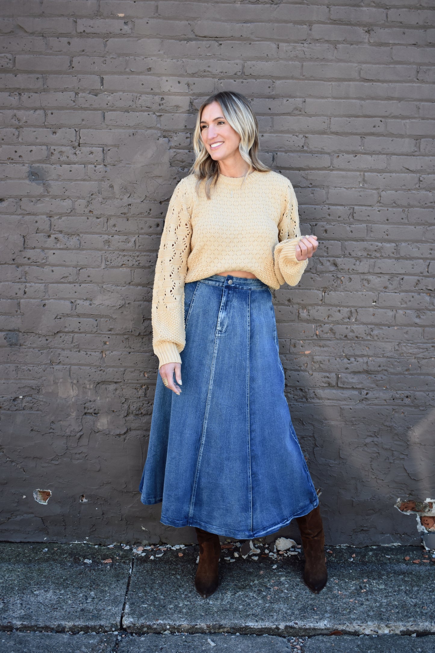 Denim swing midi skirt with seam detail along front, medium wash, button closure.