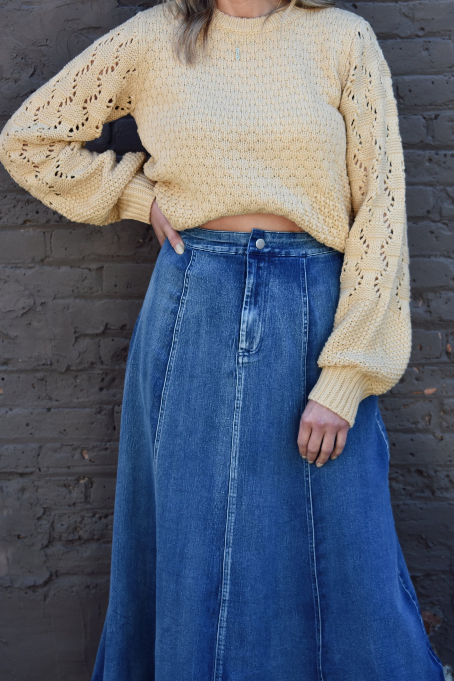 Denim swing midi skirt with seam detail along front, medium wash, button closure.