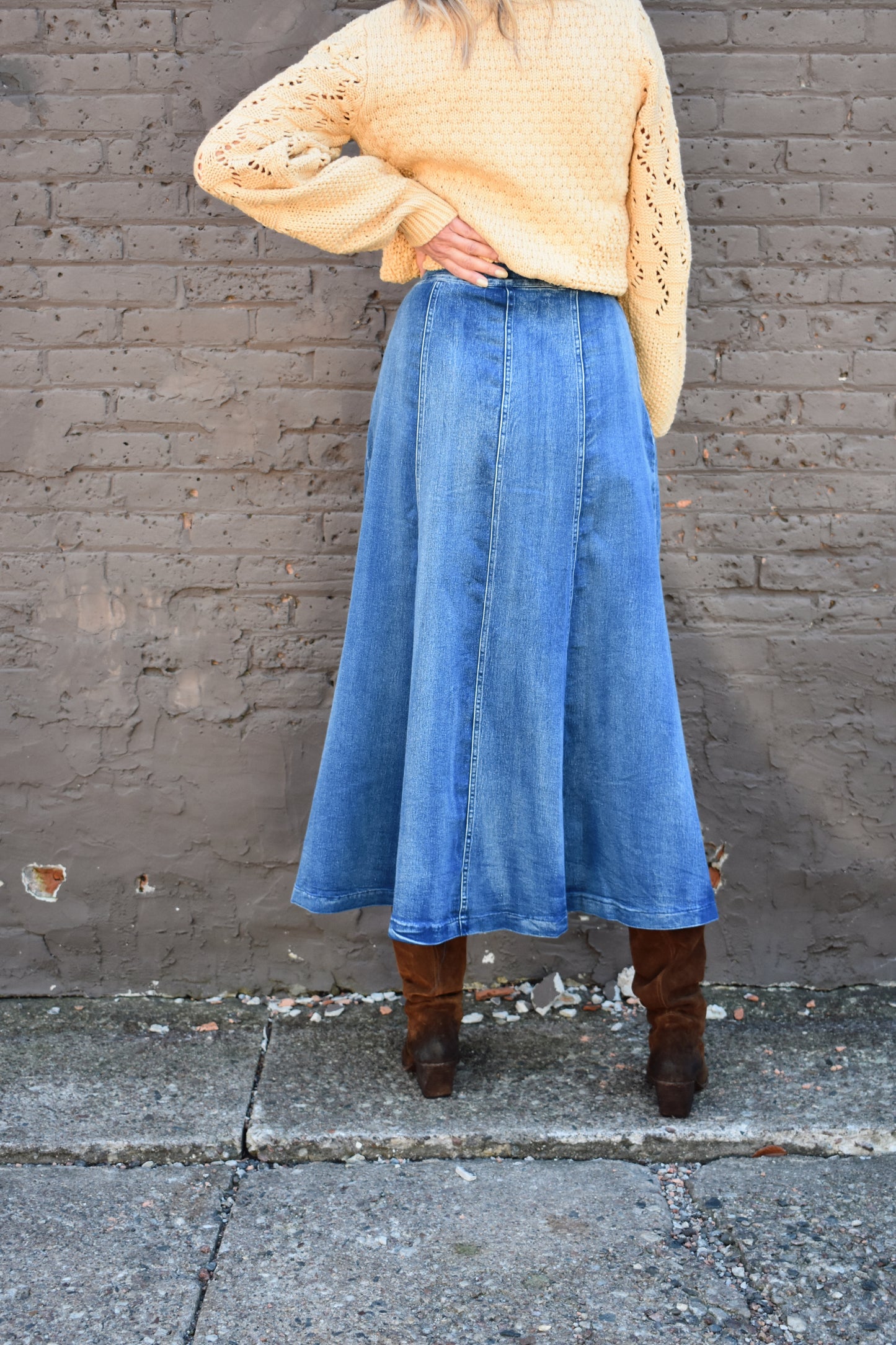 Denim swing midi skirt with seam detail along front, medium wash, button closure.