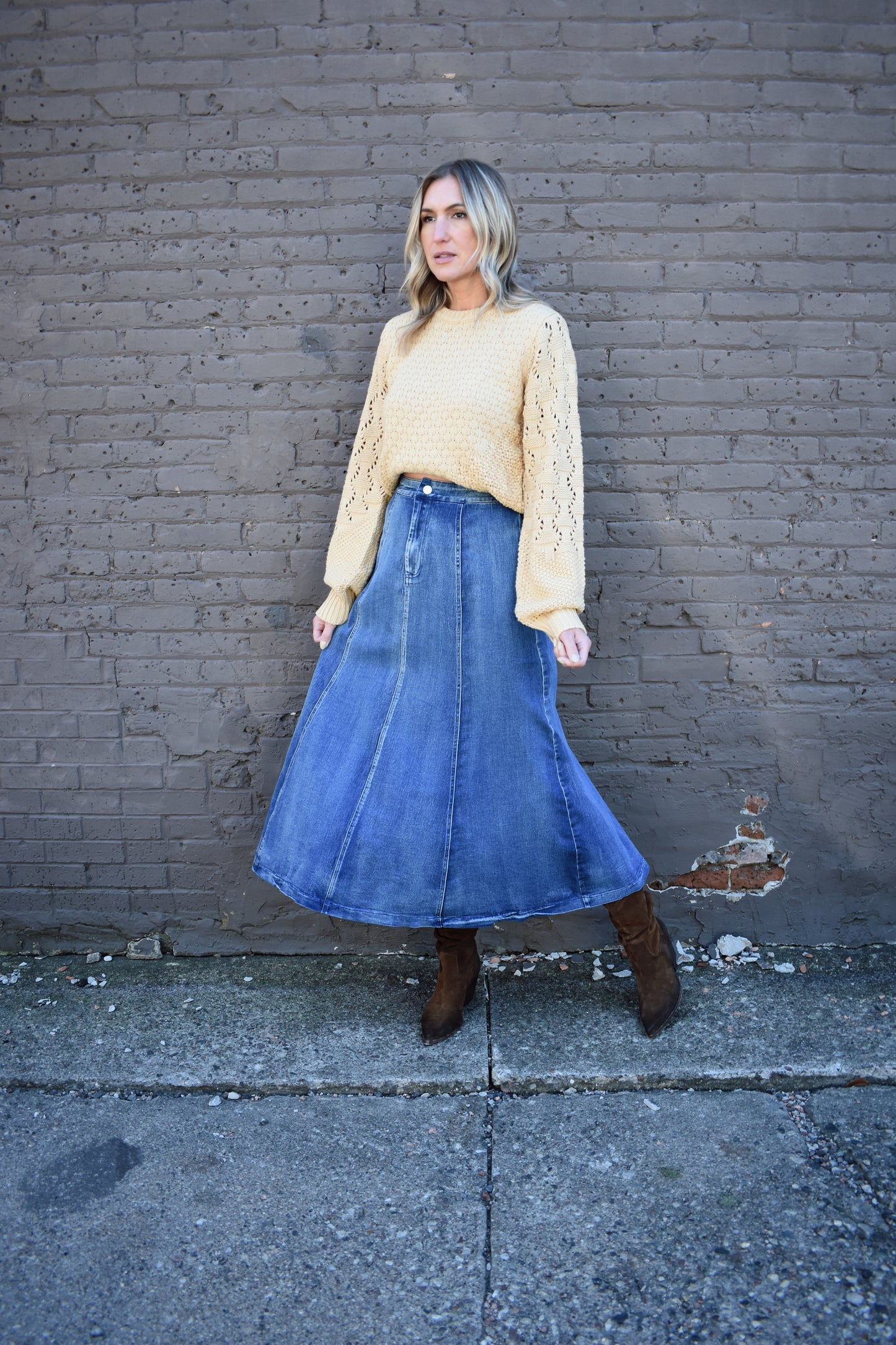 Denim swing midi skirt with seam detail along front, medium wash, button closure.
