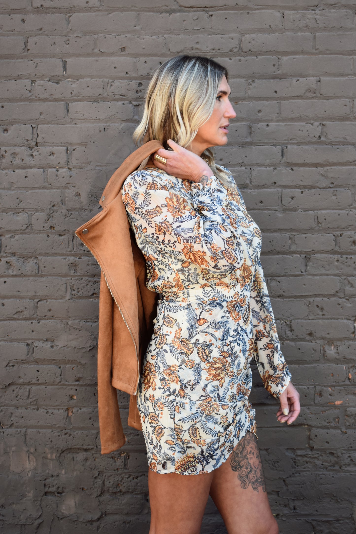 blue and taupe floral printed long sleeve mini dress with ivory background. Wrap skirt. mock neck with tie.