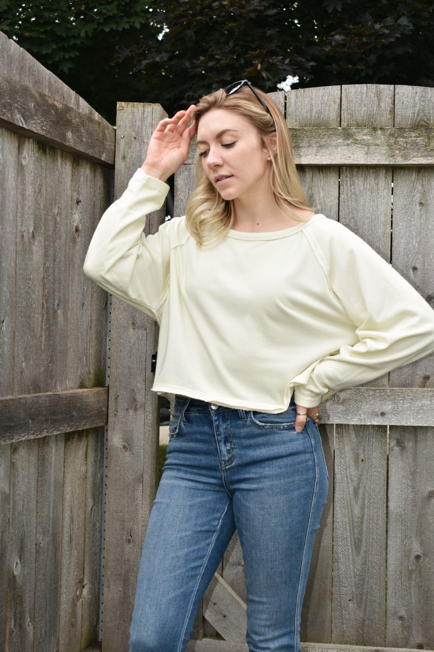 athleisure style long sleeve sweatshirt with raglan style sleeves slight acid wash boat neck and boxy fit