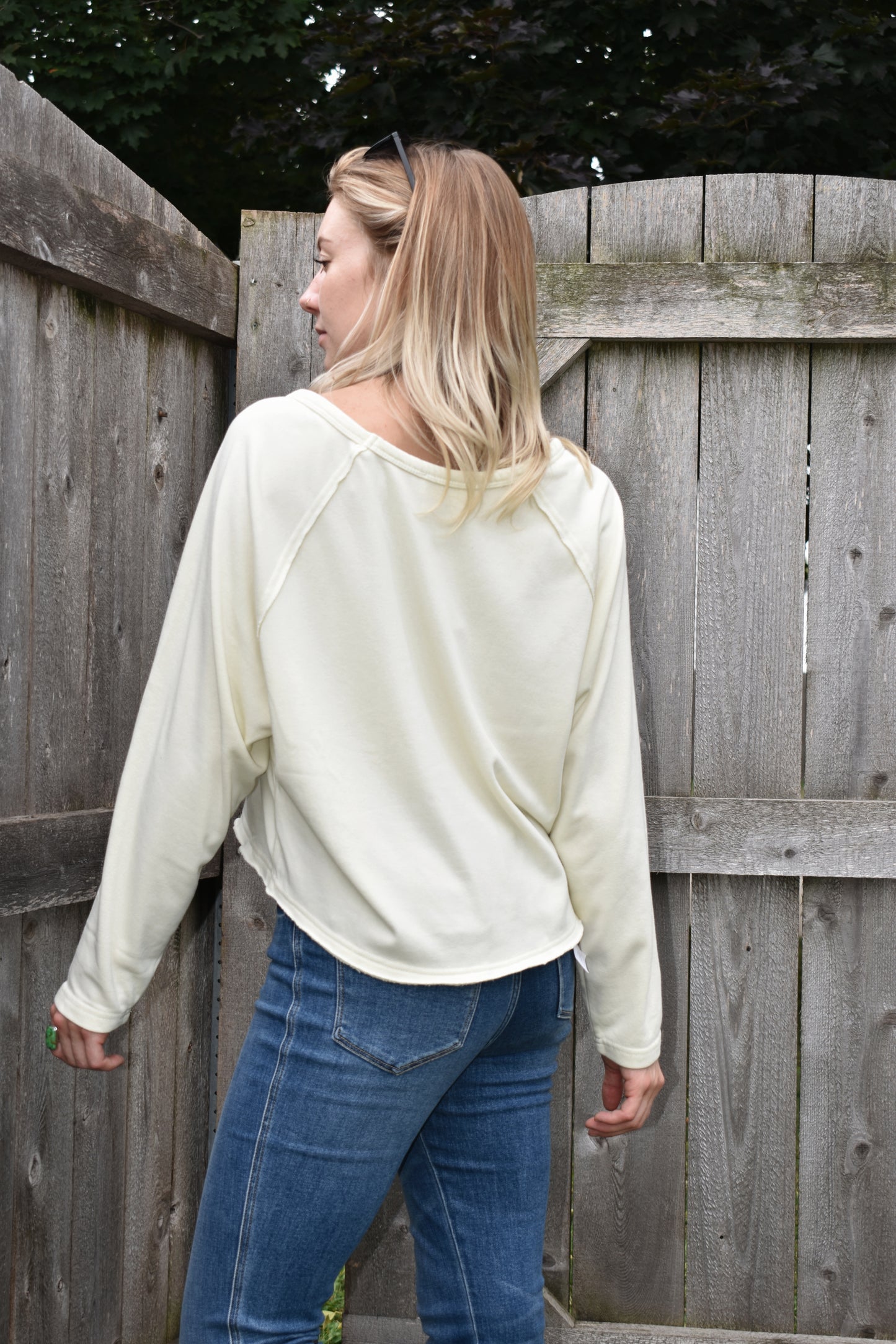 athleisure style long sleeve sweatshirt with raglan style sleeves slight acid wash boat neck and boxy fit