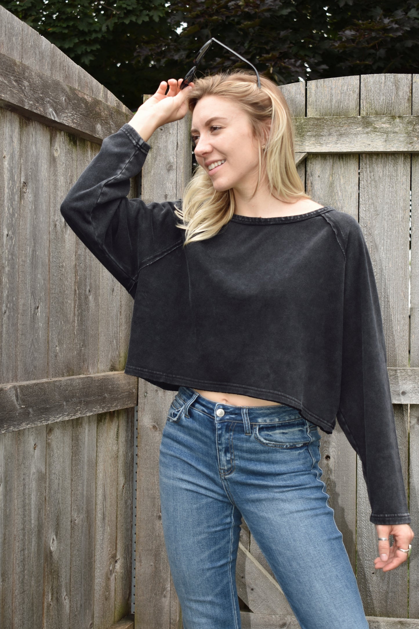 athleisure style long sleeve sweatshirt with raglan style sleeves slight acid wash boat neck and boxy fit