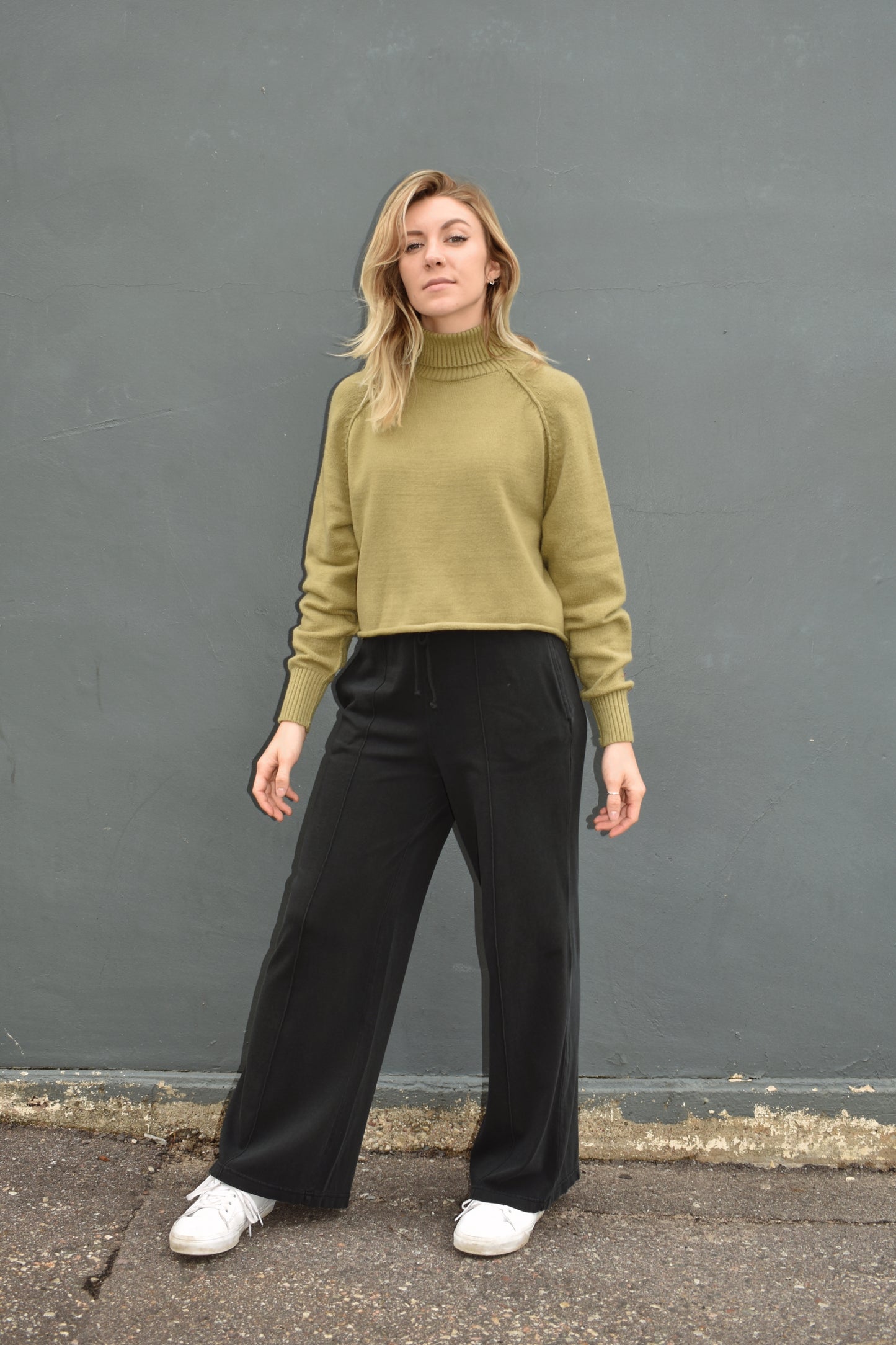 black wide leg athleisure pants with elastic waistband with drawstring, pockets and seam detail down the front of the legs.
