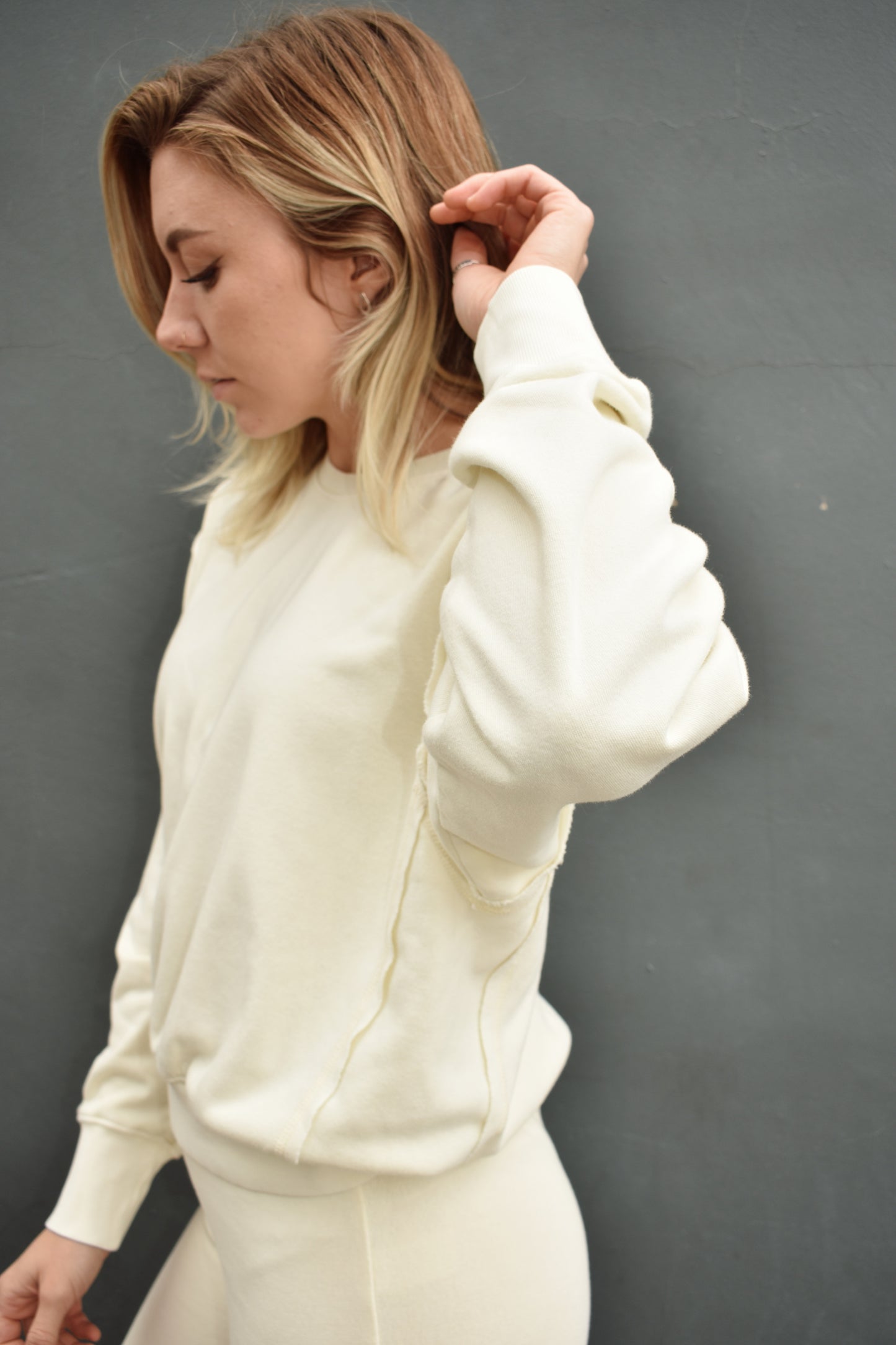 cream drop shoulder full length sweatshirt, no hood, raw hem edge detail, ribbed cuffs