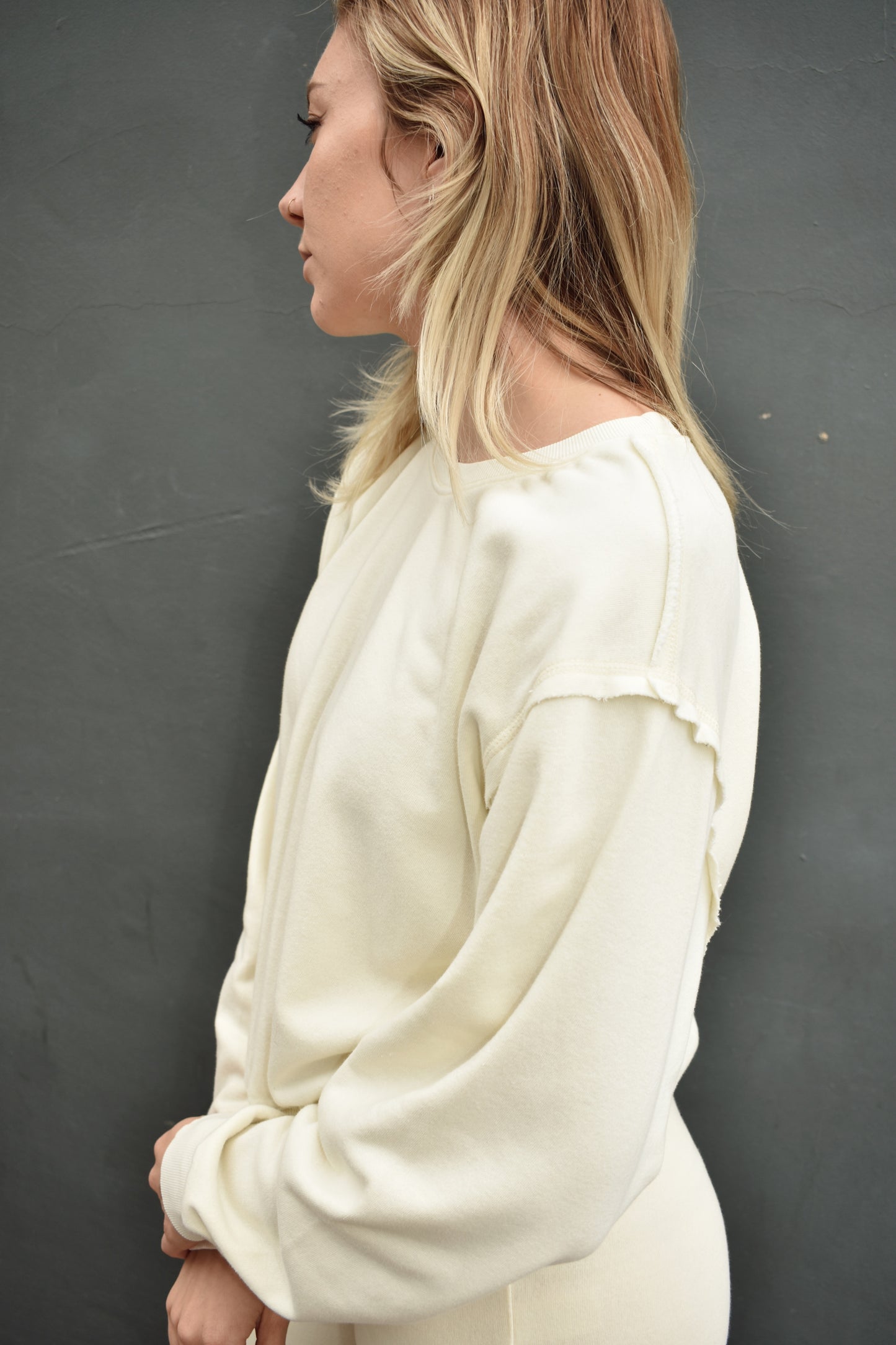 cream drop shoulder full length sweatshirt, no hood, raw hem edge detail, ribbed cuffs