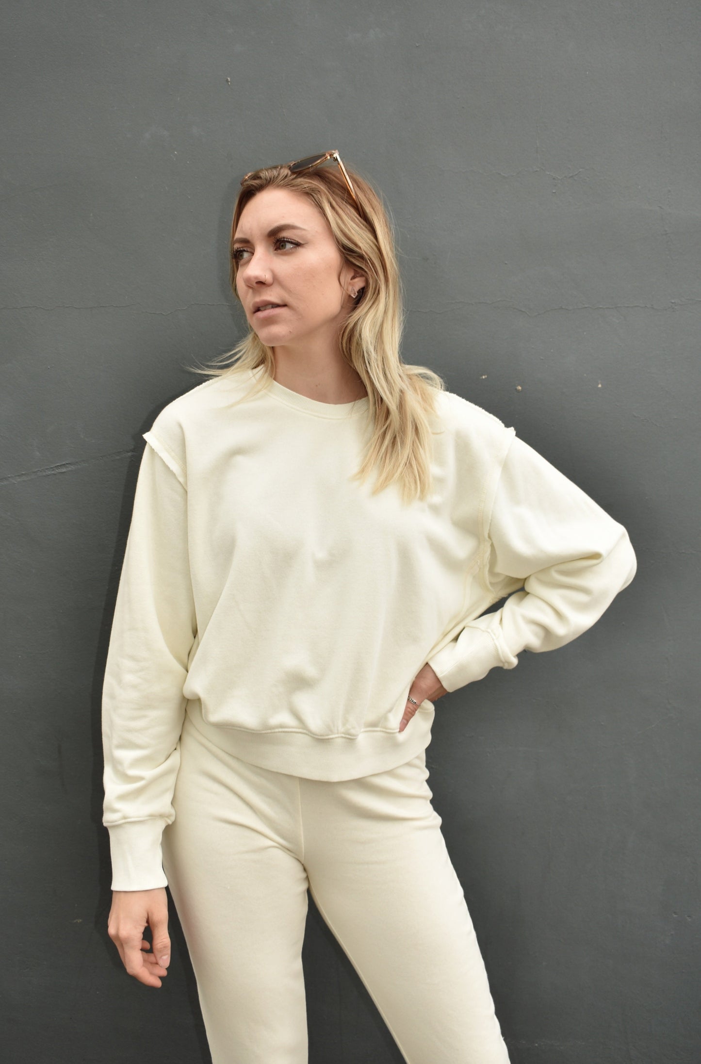 cream drop shoulder full length sweatshirt, no hood, raw hem edge detail, ribbed cuffs