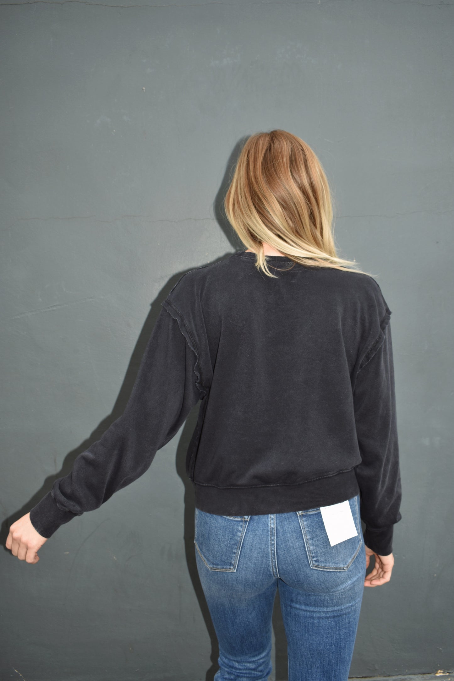black drop shoulder full length sweatshirt, no hood, raw hem edge detail, ribbed cuffs